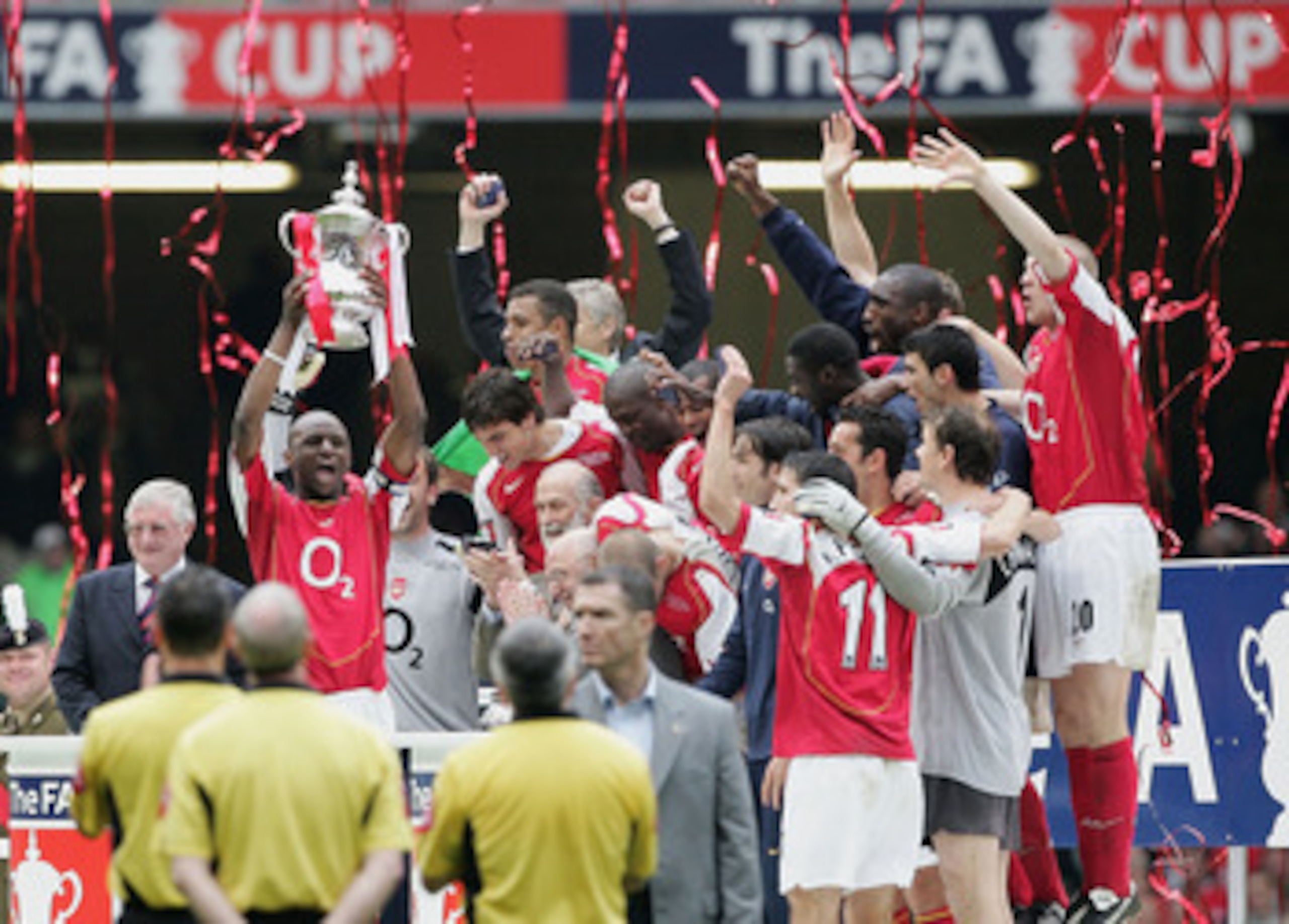 CARDIFF, UNITED KINGDOM - MAY 21: Arsenal captain, Patrick Vieira, holds the trophy aloft as team mates celebrate after winning the FA Cup Final between Arsenal and Manchester United 5-4 on penalty's at The Millennium Stadium on May 21, 2005 in Cardiff, W