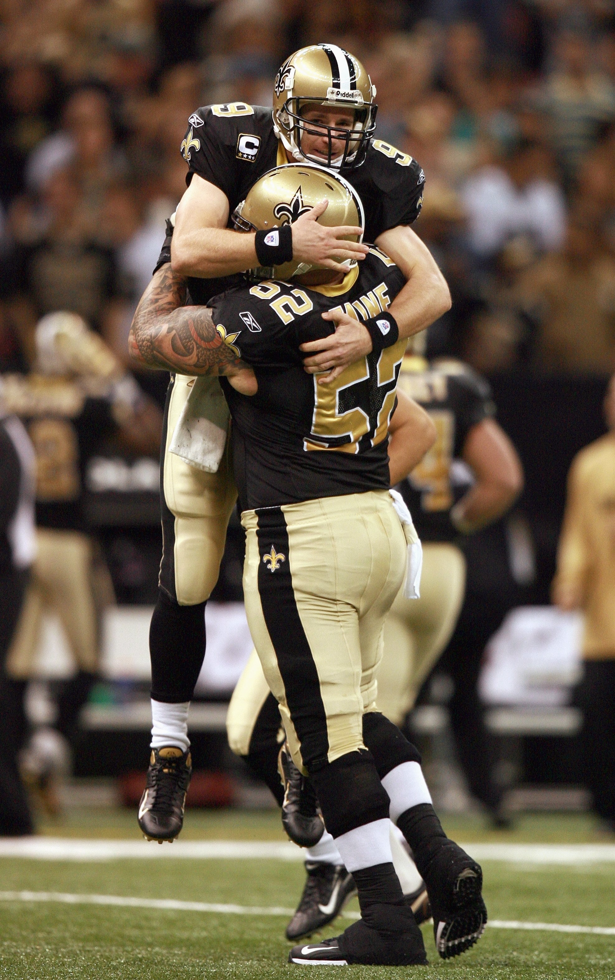 NEW ORLEANS - OCTOBER 21: Quarterback Drew Brees #9 of the New Orleans Saints celebrates with center Jeff Faine #52 after Brees threw a touchdown pass in the first quarter while taking on the Atlanta Falcons at the Superdome on October 21, 2007 in New Orl