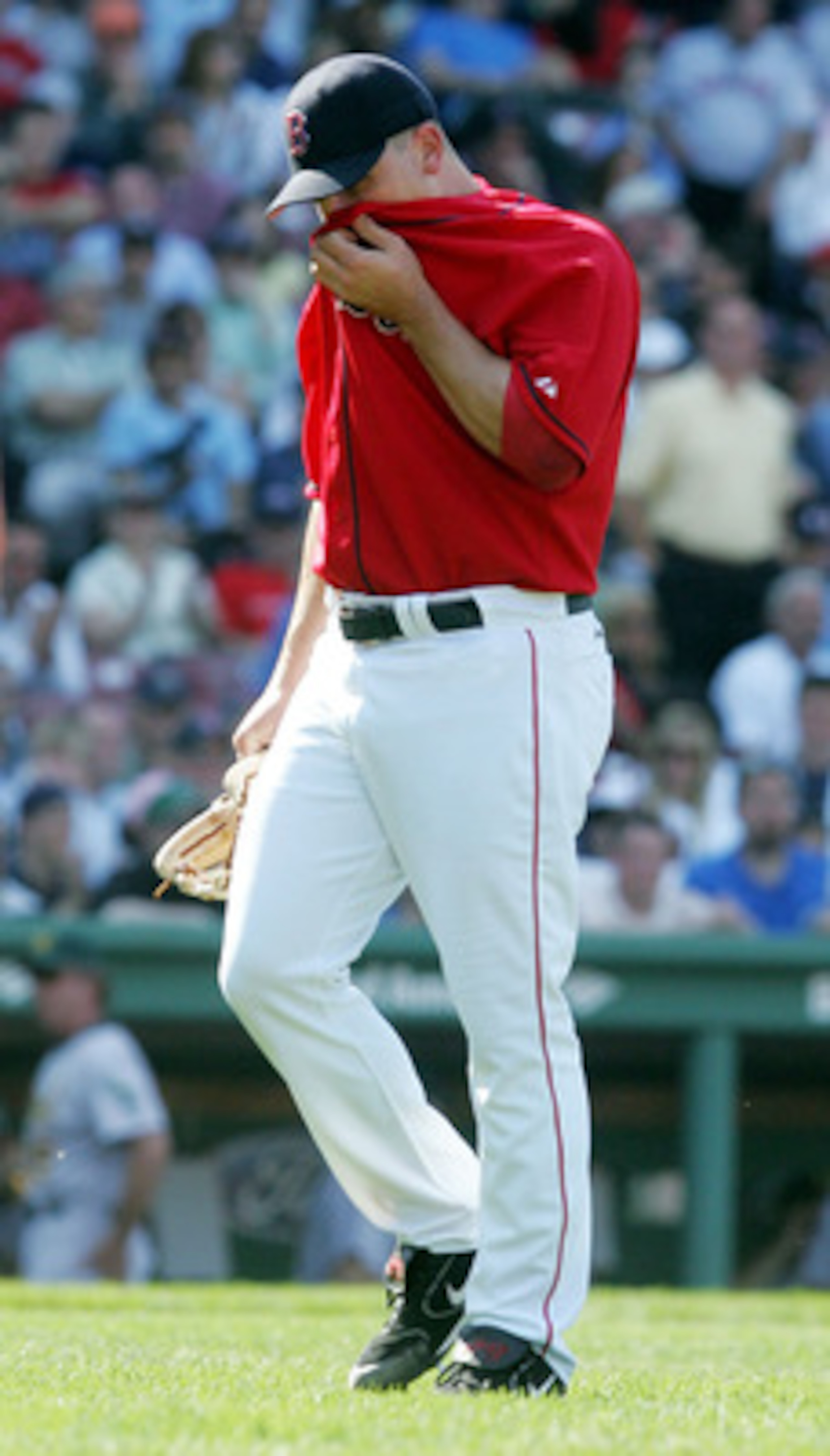 BOSTON, MA - MAY 11: Keith Foulke #29 of the Boston Red Sox walks off the field after blowing a three run lead against the Oakland Athletics during a game at Fenway Park on May 11, 2005 in Boston, Massachusetts.The Red Sox defeated the Athletics 6-5.   (P
