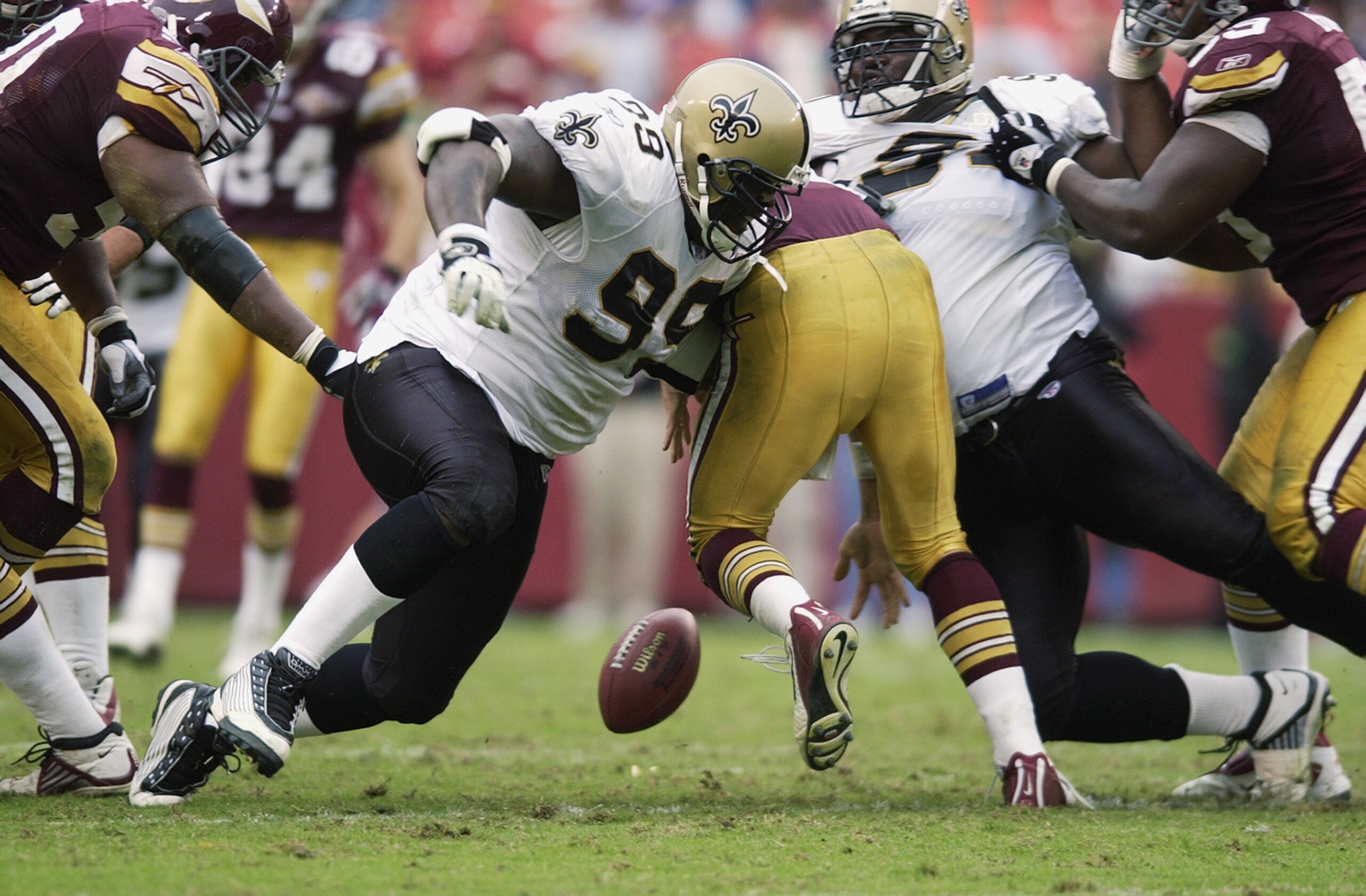 LANDOVER, MD - OCTOBER 13:  Norman Hand #99 of the New Orleans Saints tries to fall on a fumble by Patrick Ramsey #11 (C) of the Washington Redskins at FedEx Field on October 13, 2002 in Landover, Maryland. (Photo by Ezra Shaw/Getty Images)