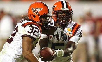 MIAMI, FL - JANUARY 03:  Tyrod Taylor #5 of the Virginia Tech Hokies hands the ball off to Darren Evans #32 against the Stanford Cardinal during the 2011 Discover Orange Bowl at Sun Life Stadium on January 3, 2011 in Miami, Florida. Stanford won 40-12.  (