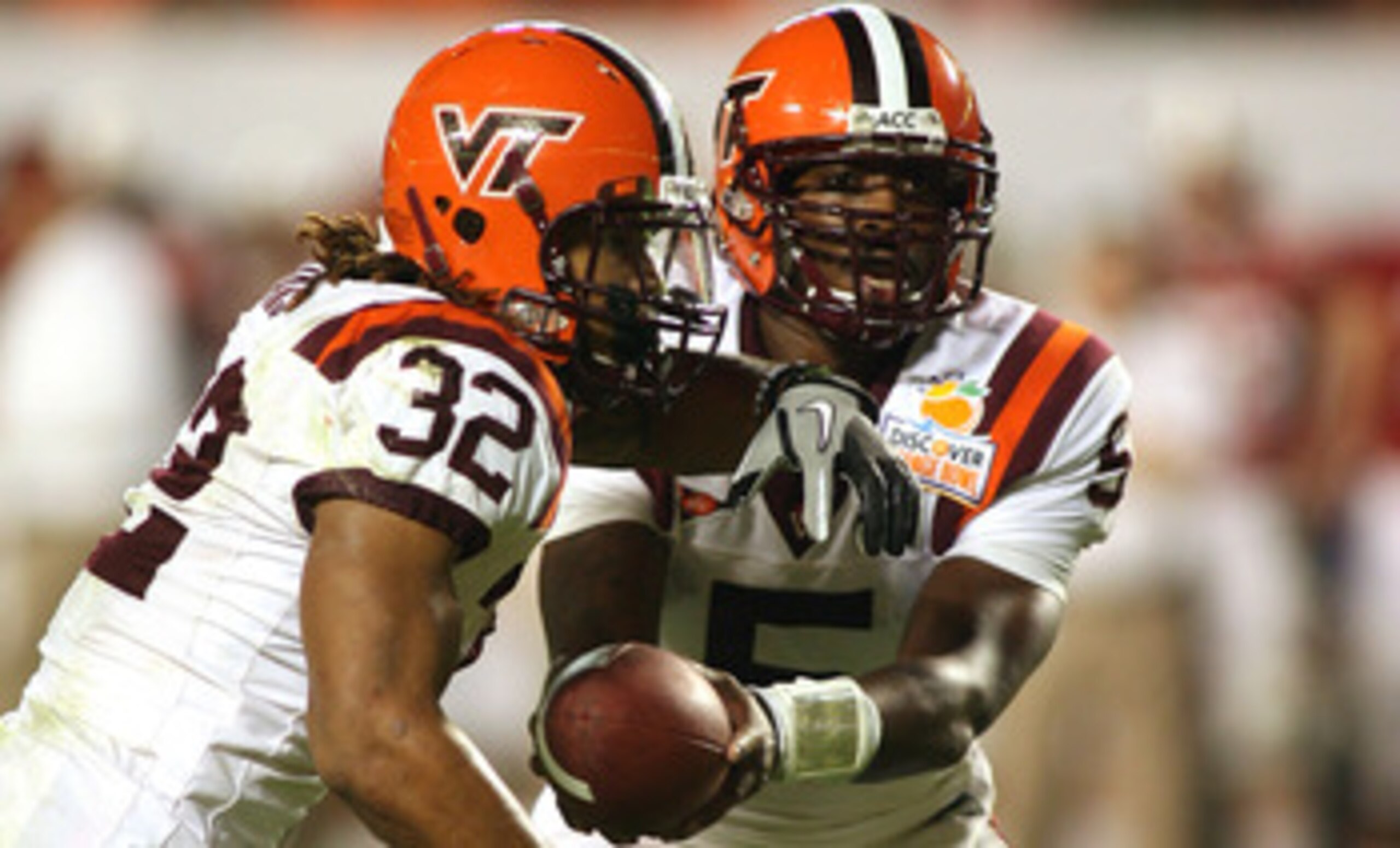 MIAMI, FL - JANUARY 03:  Tyrod Taylor #5 of the Virginia Tech Hokies hands the ball off to Darren Evans #32 against the Stanford Cardinal during the 2011 Discover Orange Bowl at Sun Life Stadium on January 3, 2011 in Miami, Florida. Stanford won 40-12.  (