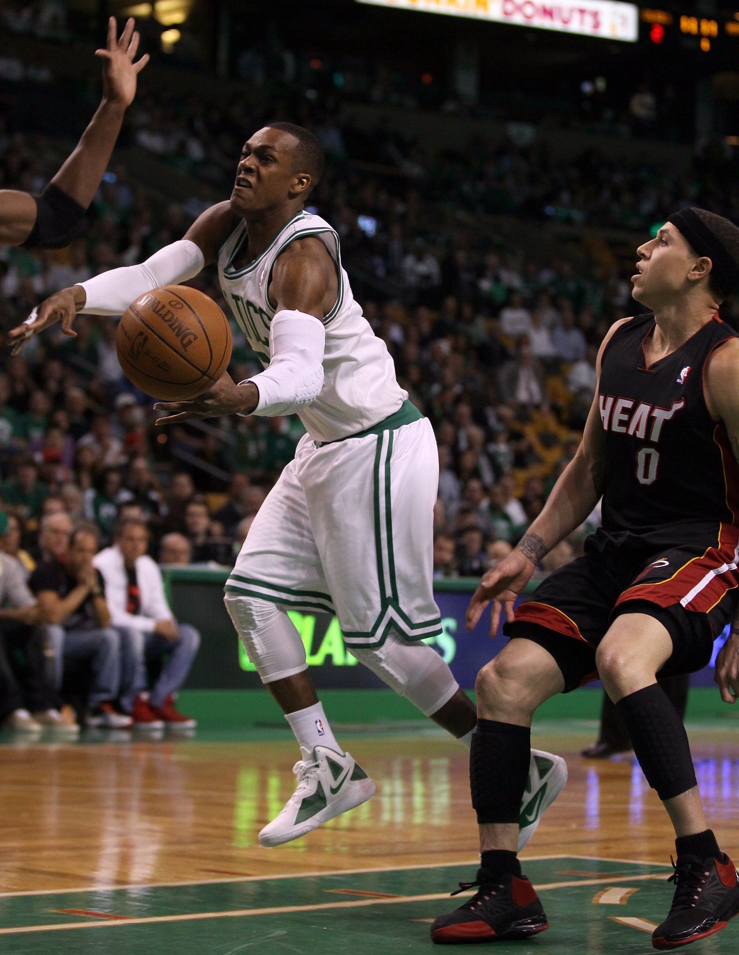 BOSTON, MA - MAY 09: Rajon Rondo #9 of the Boston Celtics is tripped by Mike Bibby #0 of the Miami Heat in Game Four of the Eastern Conference Semifinals in the 2011 NBA Playoffs on May 9, 2011 at the TD Garden in Boston, Massachusetts. NOTE TO USER: Use BOSTON, MA - MAY 09: Rajon Rondo #9 of the Boston Celtics is tripped by Mike Bibby #0 of the Miami Heat in Game Four of the Eastern Conference Semifinals in the 2011 NBA Playoffs on May 9, 2011 at the TD Garden in Boston, Massachusetts. NOTE TO USER: Use
