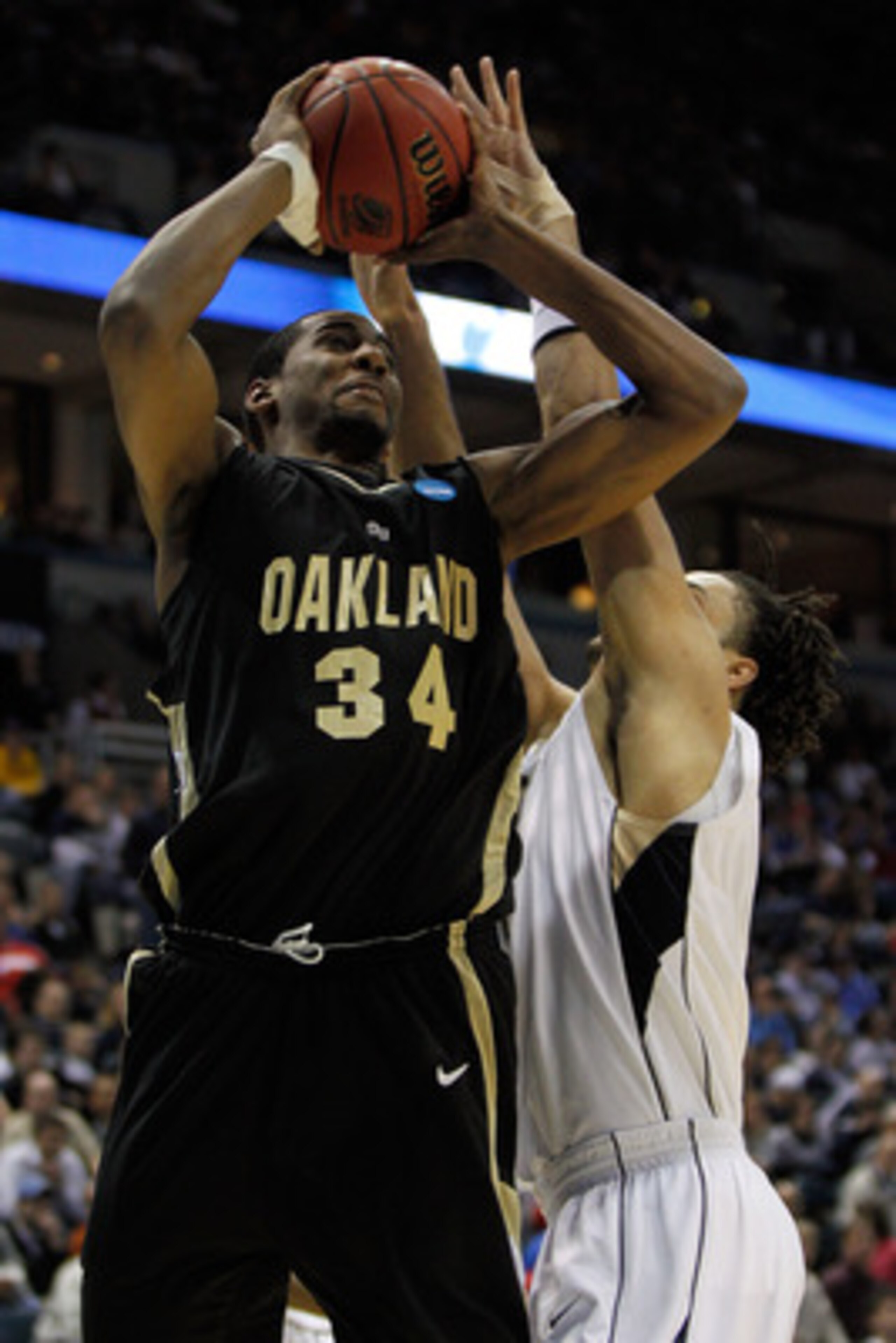 MILWAUKEE - MARCH 19:  Keith Benson #34 of the Oakland Golden Grizzlies shoots over Gary McGhee #52 of the of the Pittsburgh Panthers in the first half during the first round of the 2010 NCAA men's basketball tournament at the Bradley Center on March 19, 