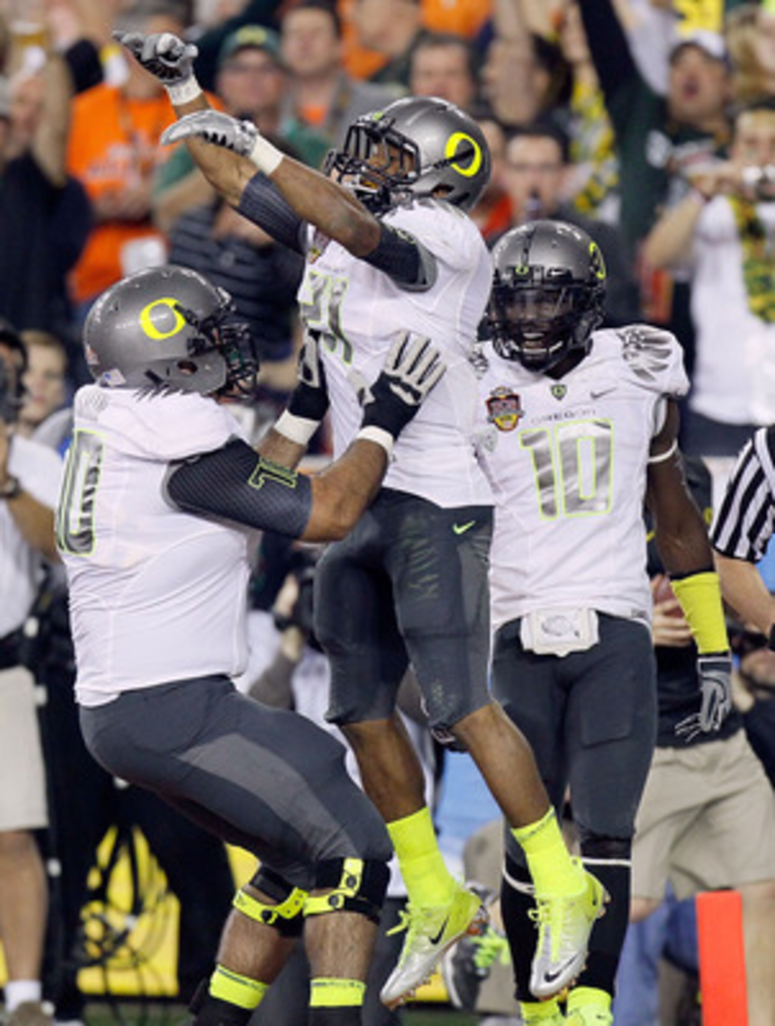 GLENDALE, AZ - JANUARY 10:  (R-L) LaMichael James #21 and Ramsen Golpashin #70 of the Oregon Ducks celebrate James' eight-yard touchdown reception in the second quarter against the Auburn Tigers during the Tostitos BCS National Championship Game at Univer