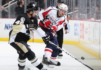 PITTSBURGH, PA - FEBRUARY 21:  Jeff Schultz  #55 of the Washington Capitals clears the puck during the NHL game against the Pittsburgh Penguins at Consol Energy Center on February 21, 2011 in Pittsburgh, Pennsylvania. The Capitals defeated the Penguins 1-