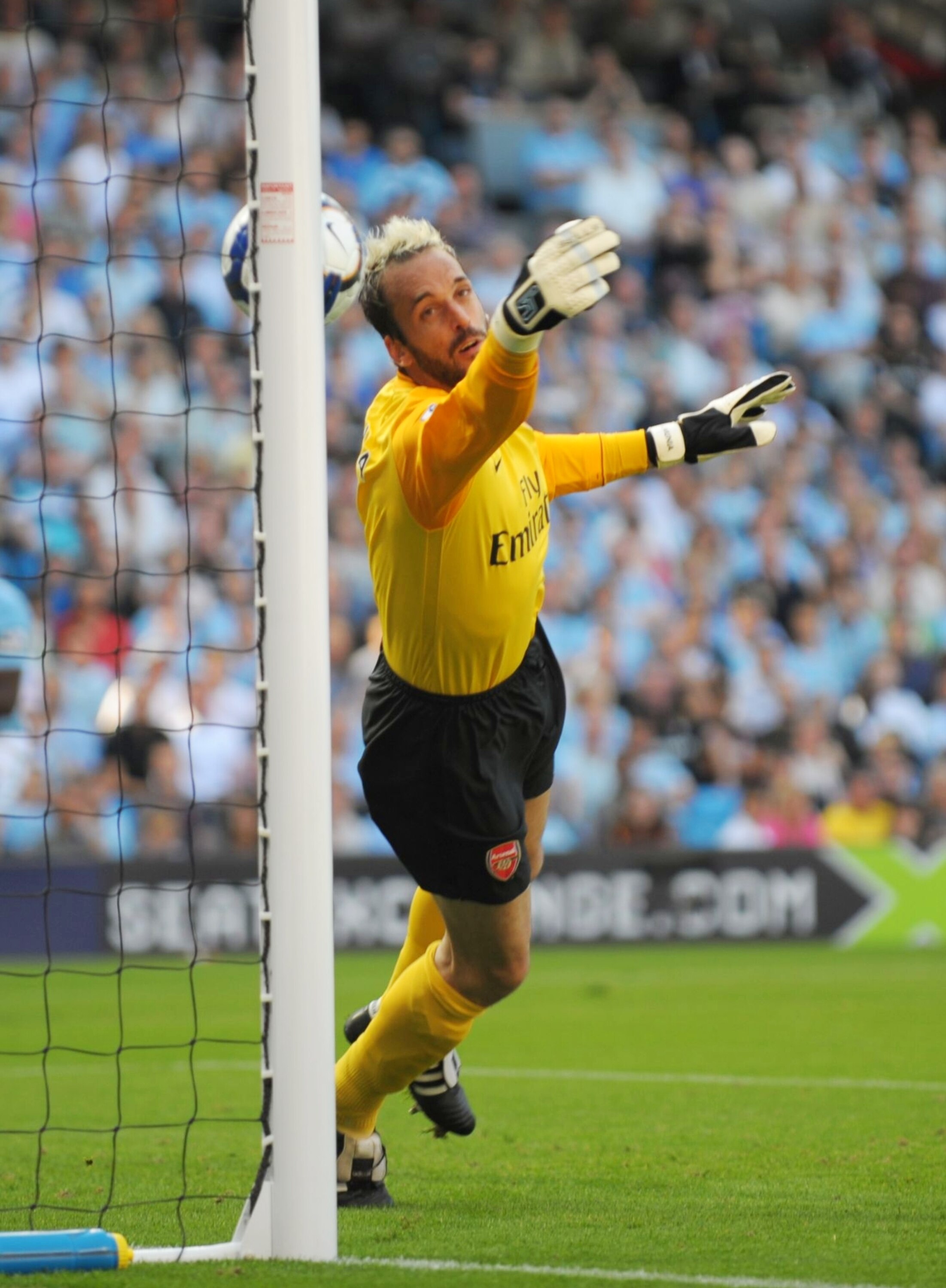MANCHESTER, ENGLAND - SEPTEMBER 12:   Manuel Almunia of Arsenal concedes an own goal as he heads the ball into his own net after it rebounded off the post and hit him during the Barclays Premier League match between Manchester City and Arsenal at the City