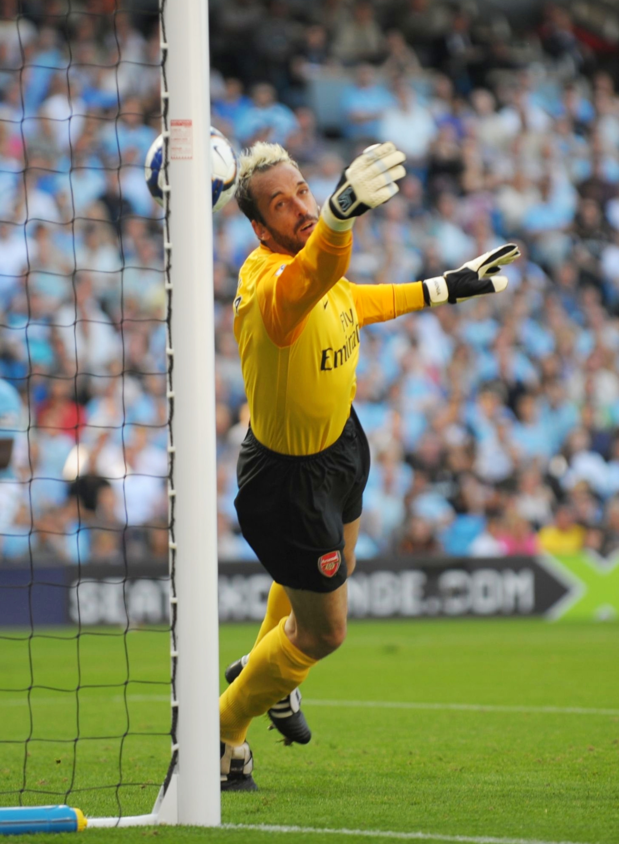 MANCHESTER, ENGLAND - SEPTEMBER 12:   Manuel Almunia of Arsenal concedes an own goal as he heads the ball into his own net after it rebounded off the post and hit him during the Barclays Premier League match between Manchester City and Arsenal at the City