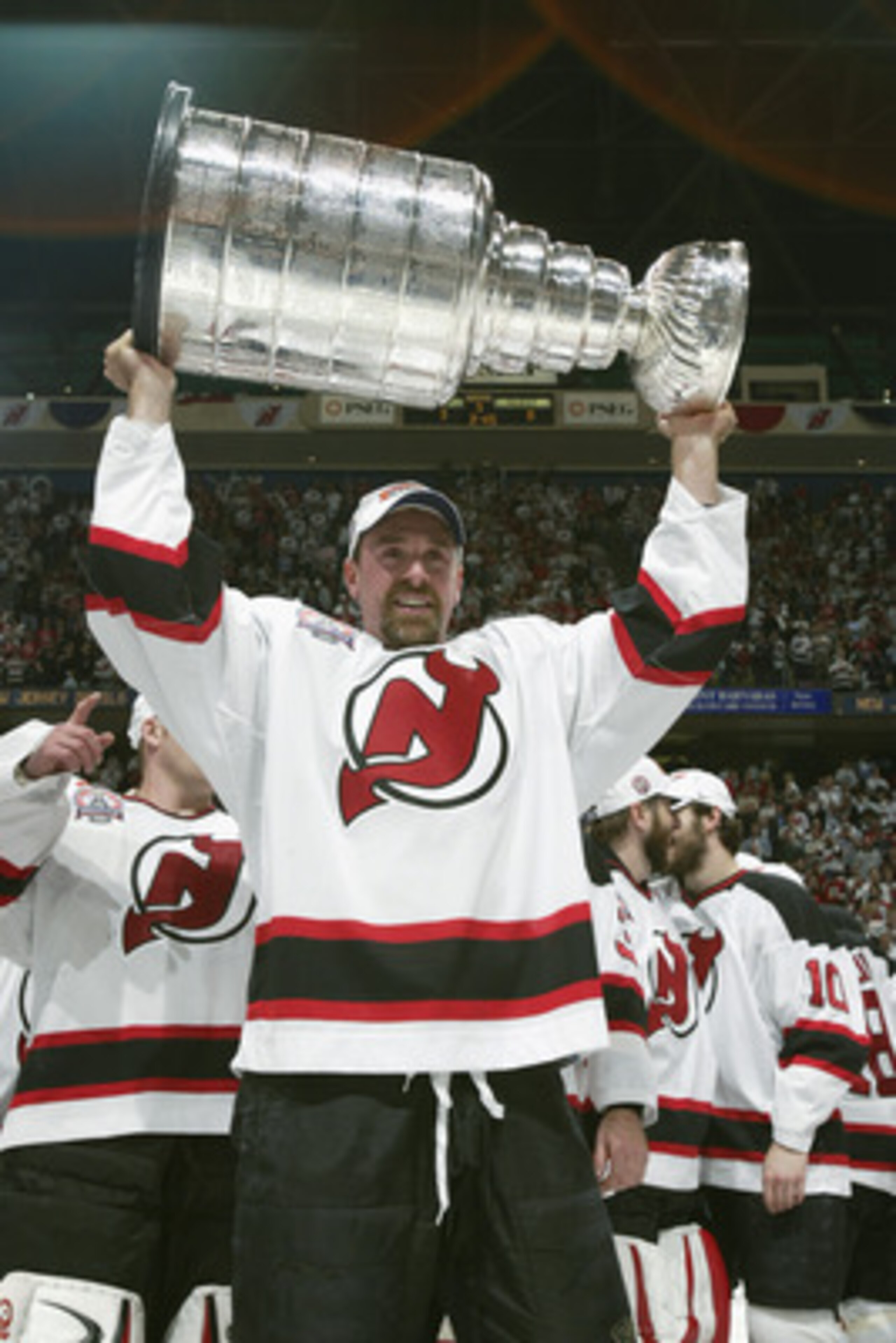 EAST RUTHERFORD, NJ - JUNE 9:  Joe Nieuwendyk #25 of the New Jersey Devils raises the Stanley Cup after defeating the Mighty Ducks of Anaheim in game seven of the 2003 Stanley Cup Finals at Continental Airlines Arena on June 9, 2003 in East Rutherford, Ne