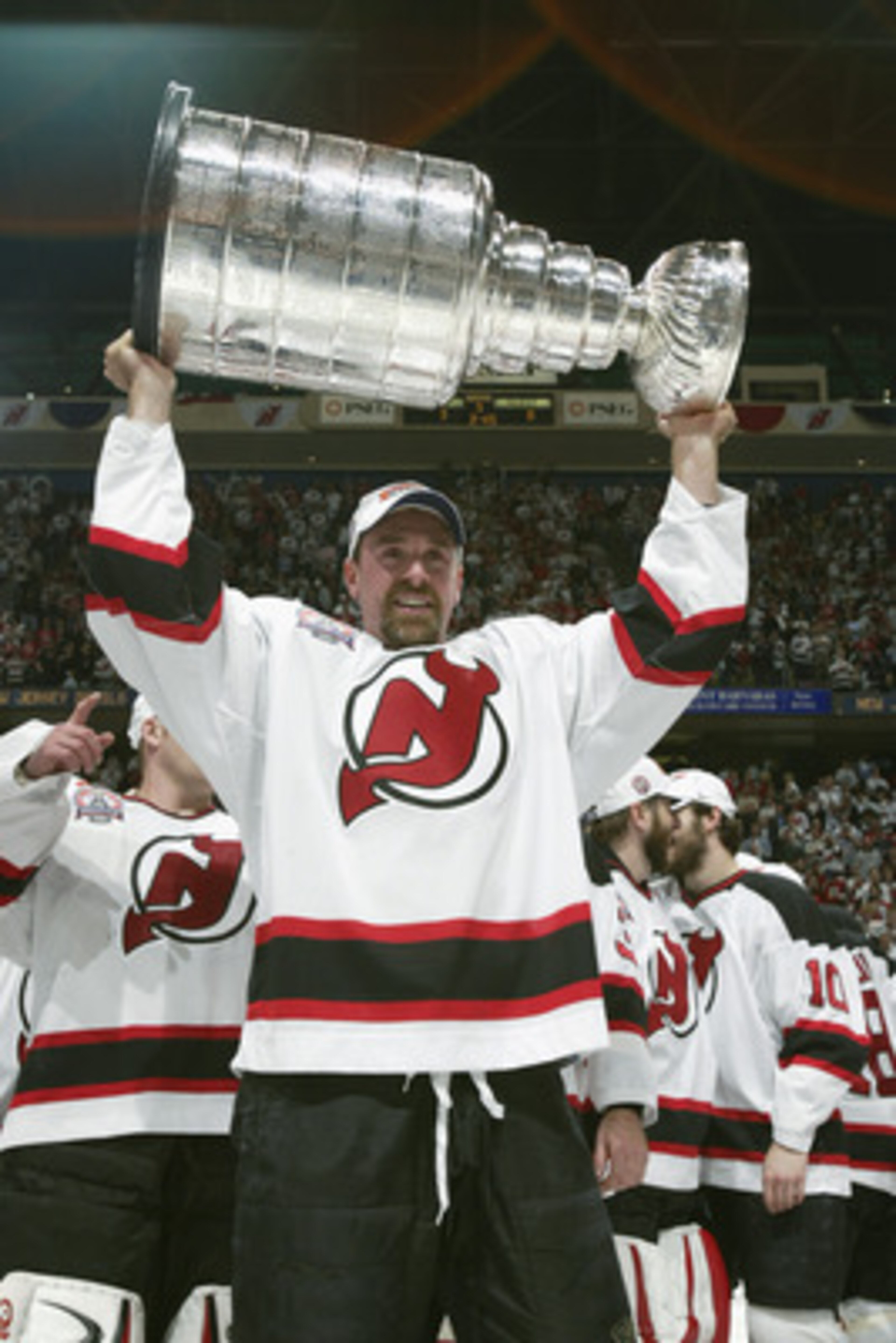 EAST RUTHERFORD, NJ - JUNE 9:  Joe Nieuwendyk #25 of the New Jersey Devils raises the Stanley Cup after defeating the Mighty Ducks of Anaheim in game seven of the 2003 Stanley Cup Finals at Continental Airlines Arena on June 9, 2003 in East Rutherford, Ne