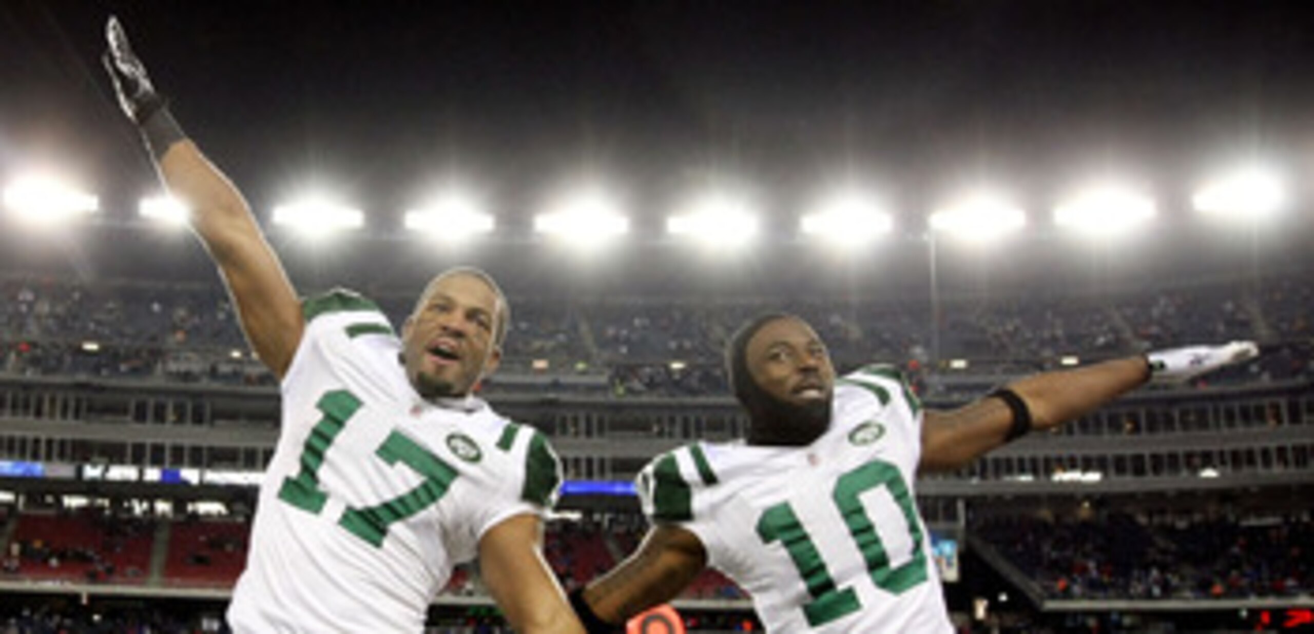 FOXBORO, MA - JANUARY 16:  Braylon Edwards #17 and Santonio Holmes #10 of the New York Jets celebrate on their way to defeating the New England Patriots 28 to 21 victory over the New England Patriots during their 2011 AFC divisional playoff game at Gillet