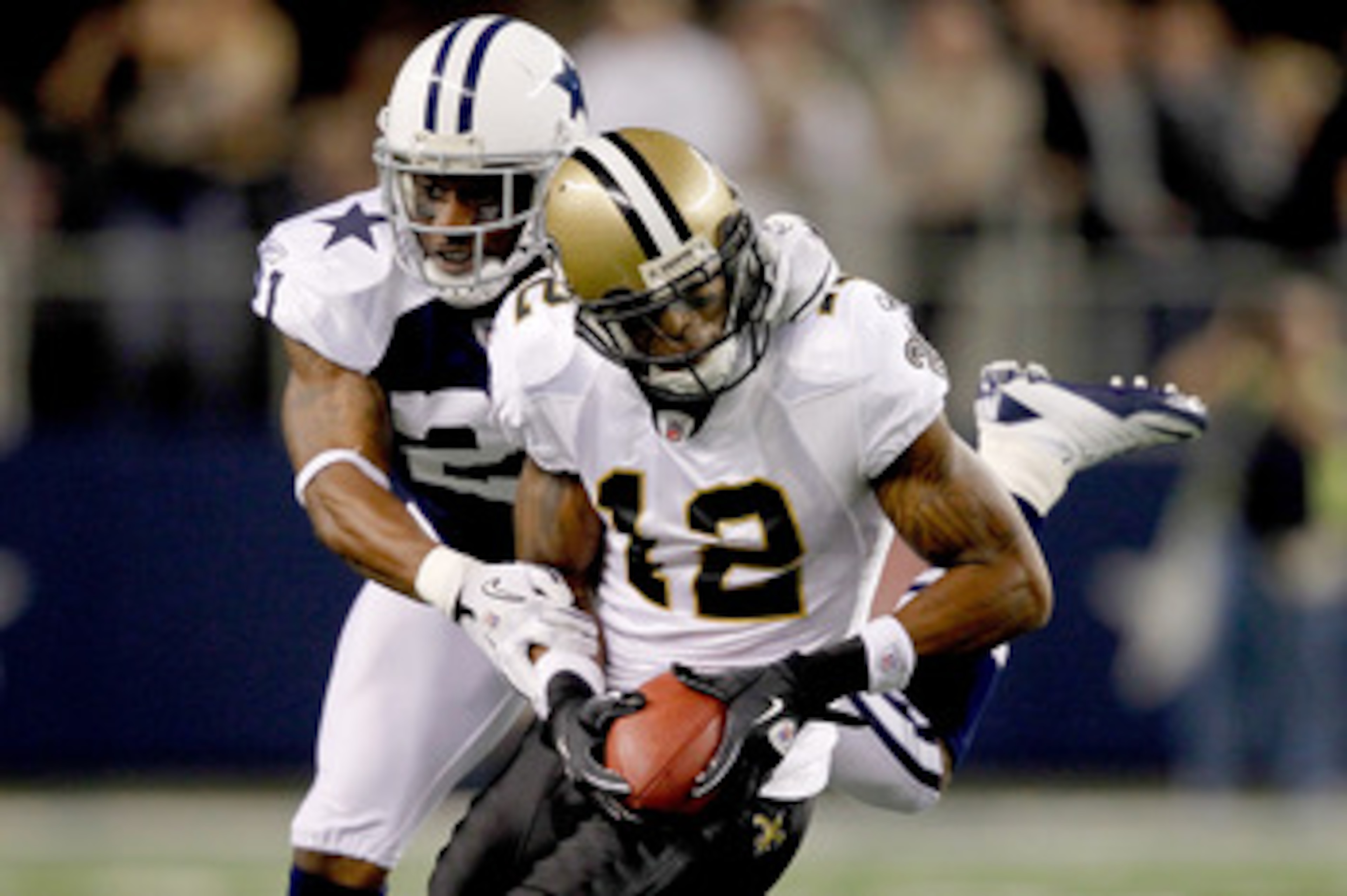 ARLINGTON, TX - NOVEMBER 25: Mike Jenkins #21 of the Dallas Cowboys tackles Marques Colston #12 of the New Orleans Saints at Cowboys Stadium on November 25, 2010 in Arlington, Texas.  (Photo by Matthew Stockman/Getty Images)