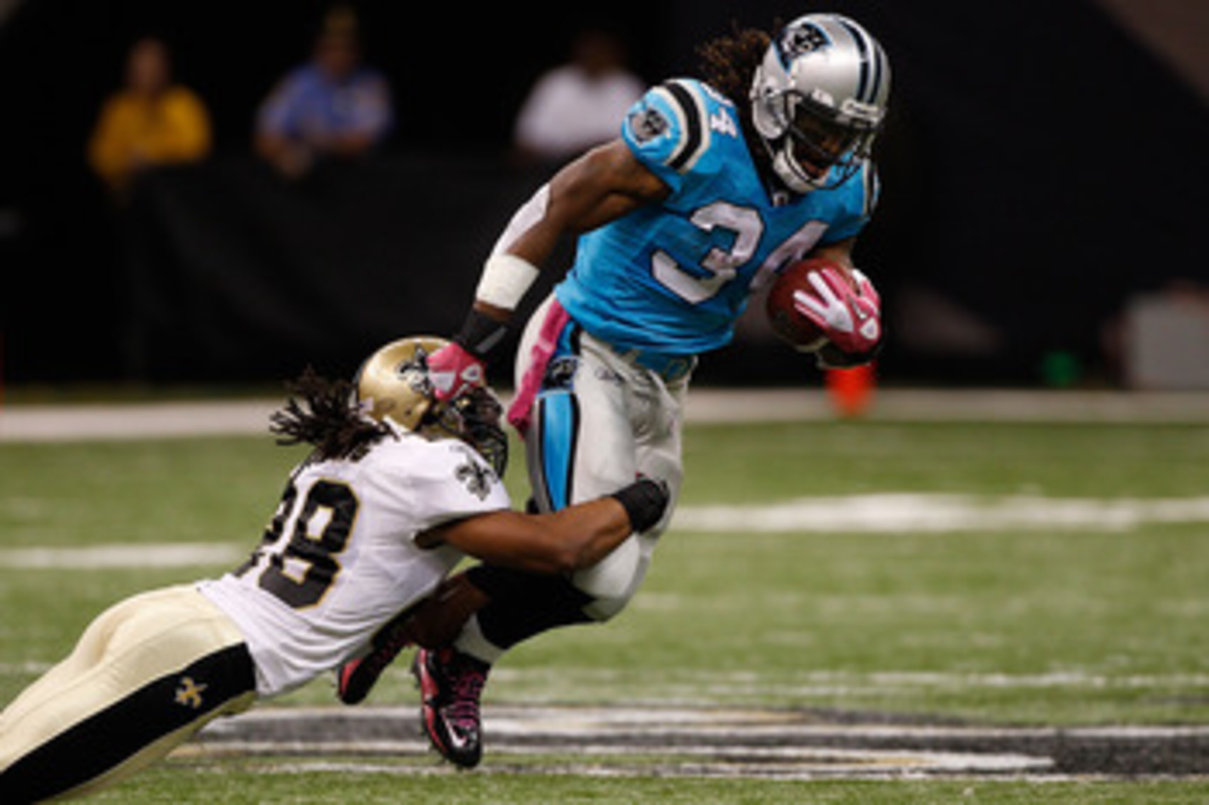 NEW ORLEANS - OCTOBER 03:  Usama Young #28 of the New Orleans Saints tackles DeAngelo Williams #34 of the Carolina Panthers at the Louisiana Superdome on October 3, 2010 in New Orleans, Louisiana.  (Photo by Chris Graythen/Getty Images)