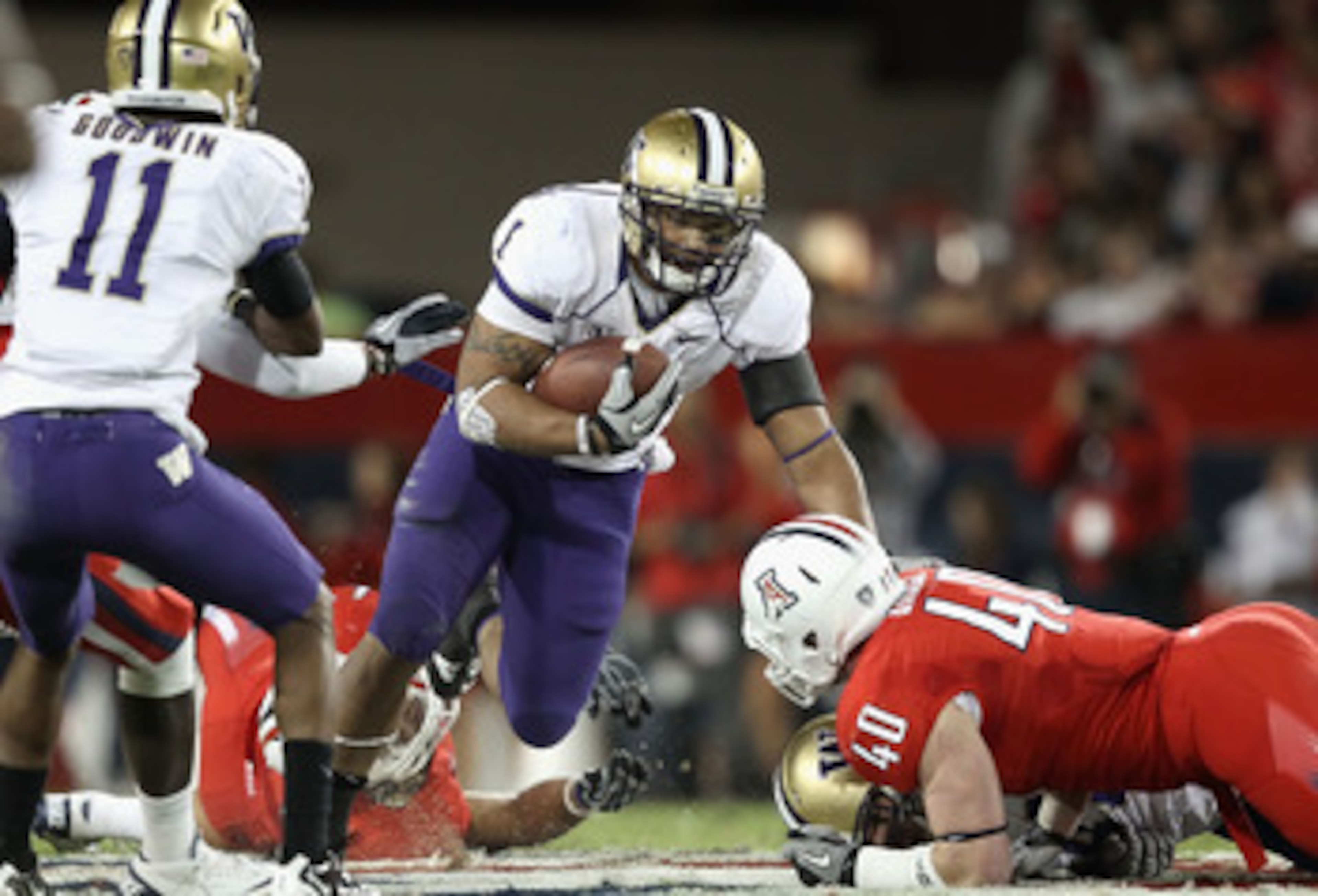 TUCSON, AZ - OCTOBER 23:  Runningback Chris Polk #1 of the Washington Huskies rushes the football during the college football game against the Arizona Wildcats at Arizona Stadium on October 23, 2010 in Tucson, Arizona. The Wildcats defeated the Huskies 44