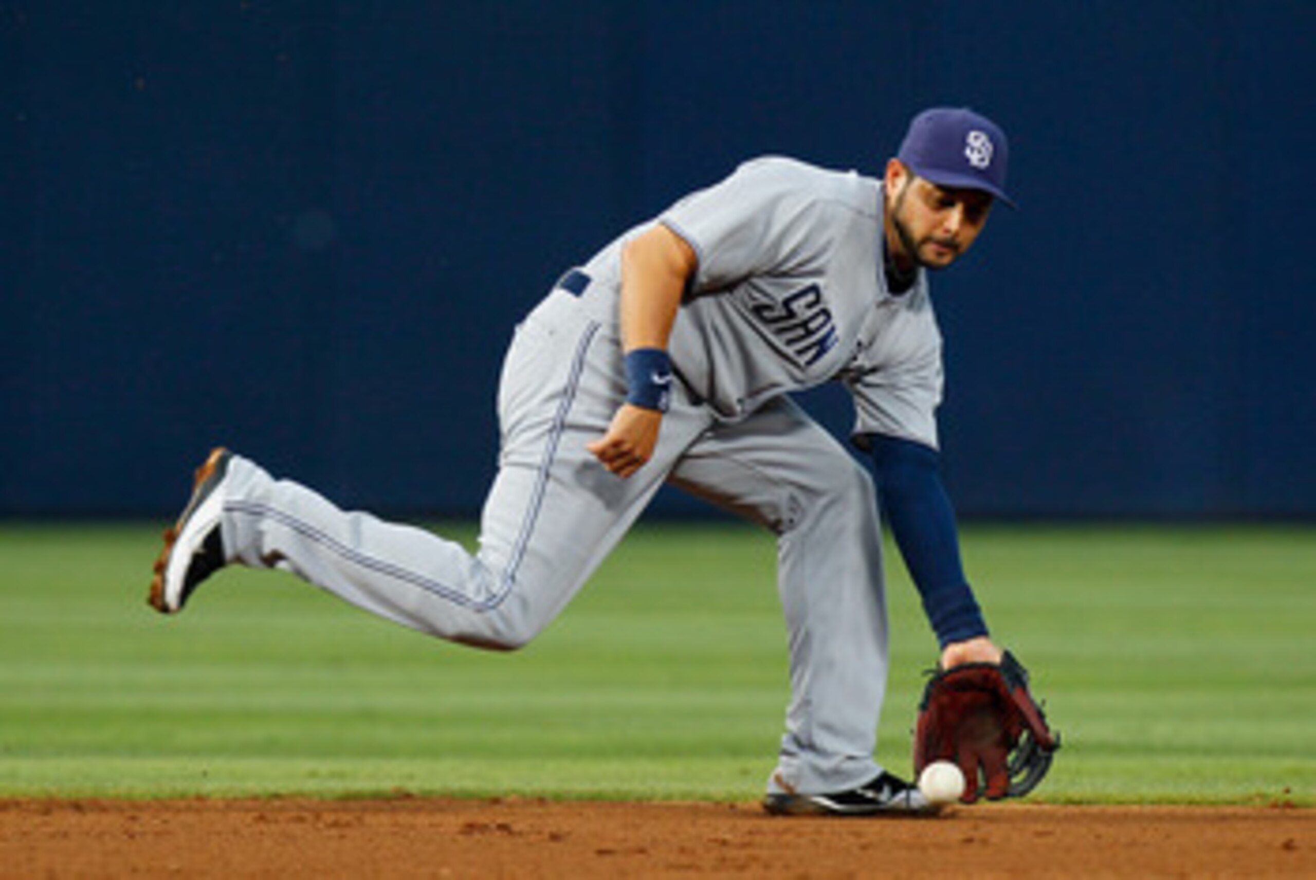 ATLANTA, GA - JUNE 01:  Jason Bartlett #8 of the San Diego Padres scoops up a ground ball hit by Jordan Schafer #1 of the Atlanta Braves in the fourth inning at Turner Field on June 1, 2011 in Atlanta, Georgia.  (Photo by Kevin C. Cox/Getty Images)