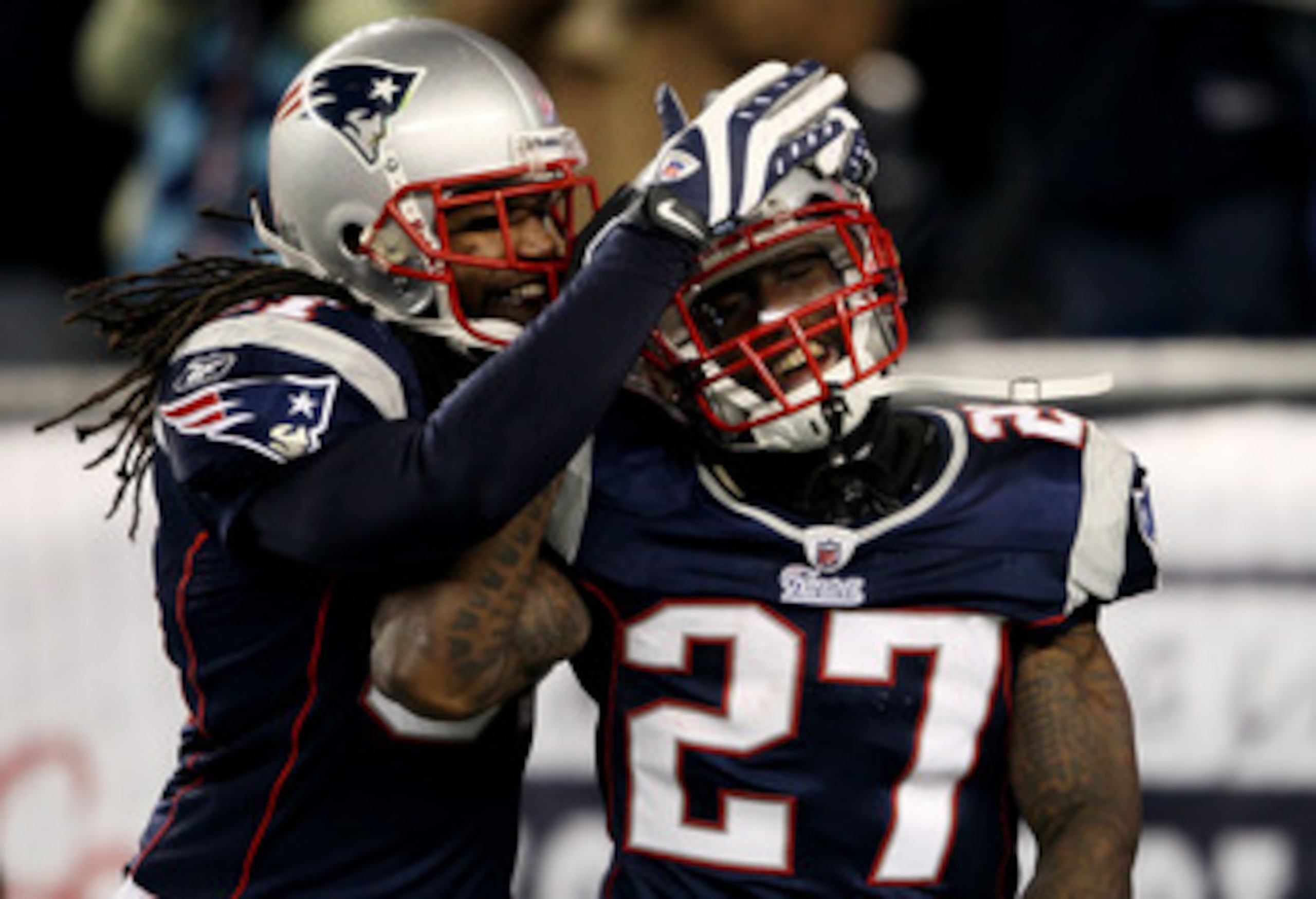 FOXBORO, MA - DECEMBER 19:  Cornerback Kyle Arrington #27 of the New England Patriots (R) is congratulated for scoring a touchdown after intercepting the ball and running 36 yards by teammate safety Brandon Meriweather #31 during the third quarter of the
