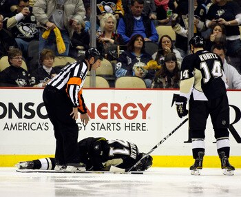 PITTSBURGH, PA - FEBRUARY 04:  Evgeni Malkin #71 of the Pittsburgh Penguins lies injured on the ice during the game against the Buffalo Sabres at Consol Energy Center on February 4, 2011 in Pittsburgh, Pennsylvania.  The Penguins defeated Buffalo 3-2.  (P