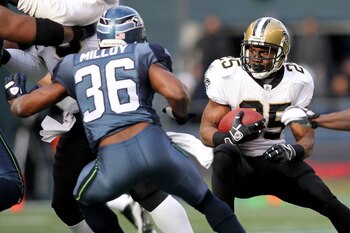SEATTLE, WA - JANUARY 08:  Reggie Bush #25 of the New Orleans Saints runs down field against Lawyer Milloy #36 of the Seattle Seahawks during the 2011 NFC wild-card playoff game at Qwest Field on January 8, 2011 in Seattle, Washington.  (Photo by Jonathan