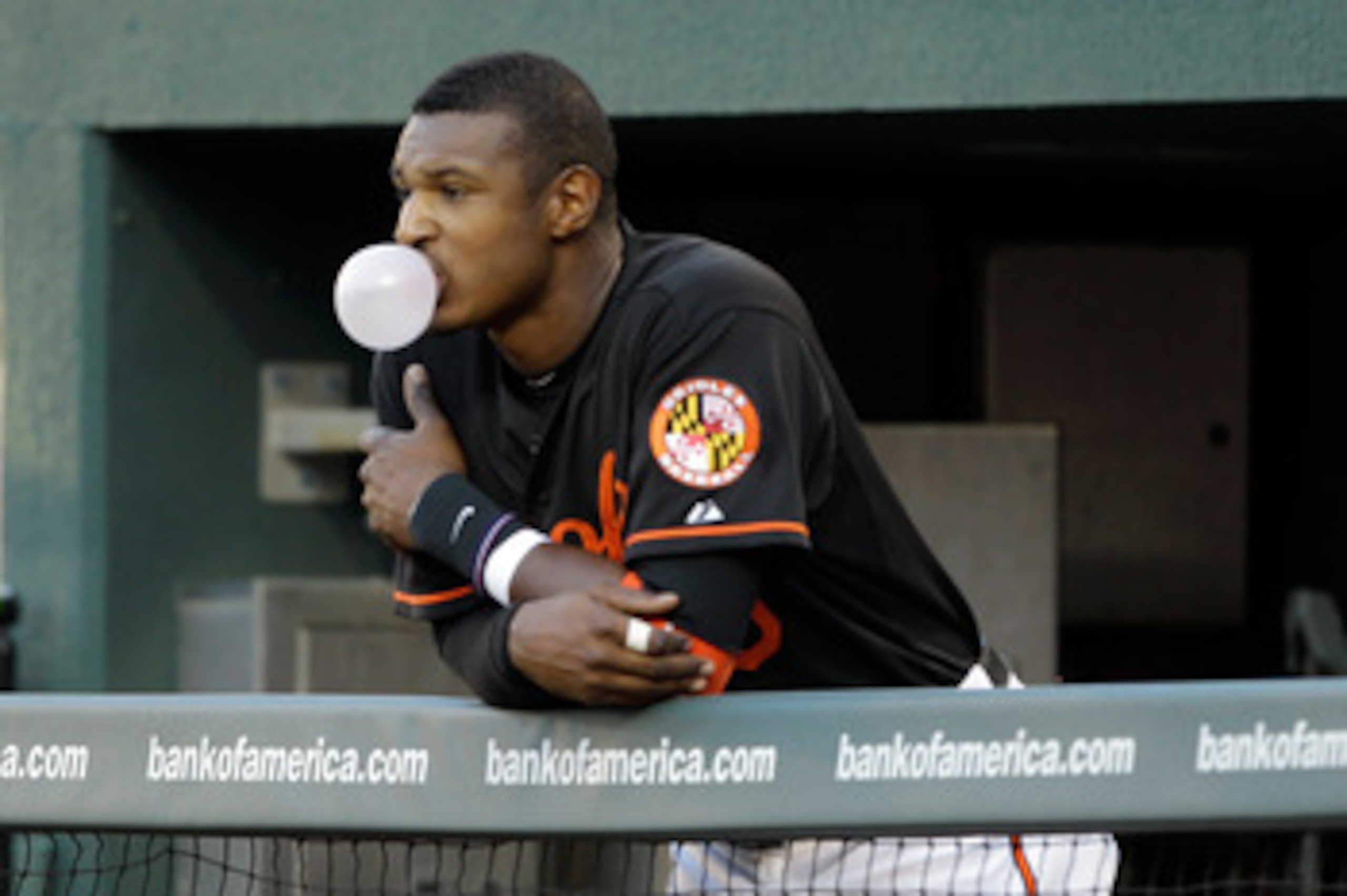 BALTIMORE, MD - JUNE 03: Adam Jones #10 of the Baltimore Orioles blows a bubble while watching the second inning from the dugout against the Toronto Blue Jays at Oriole Park at Camden Yards on June 3, 2011 in Baltimore, Maryland. (Photo by Rob Carr/Getty BALTIMORE, MD - JUNE 03: Adam Jones #10 of the Baltimore Orioles blows a bubble while watching the second inning from the dugout against the Toronto Blue Jays at Oriole Park at Camden Yards on June 3, 2011 in Baltimore, Maryland. (Photo by Rob Carr/Getty