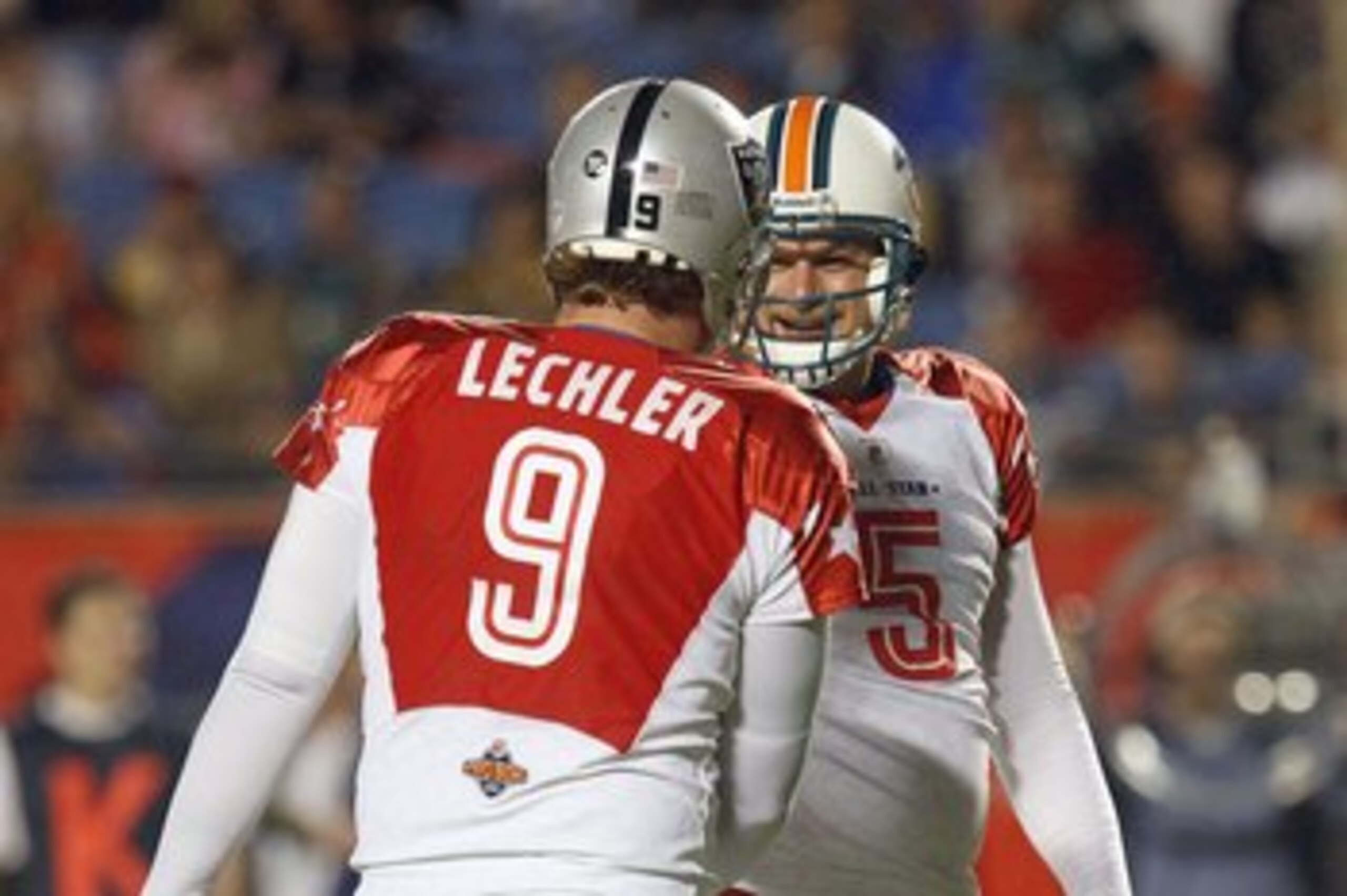 MIAMI GARDENS, FL - JANUARY 31:  Place kicker Dan Carpenter #5 of the AFC's Miami Dolphins celebrates after a play with Shane Lechler #9 of the AFC's Oakland Raiders during the 2010 AFC-NFC Pro Bowl game at Sun Life Stadium on January 31, 2010 in Miami Ga