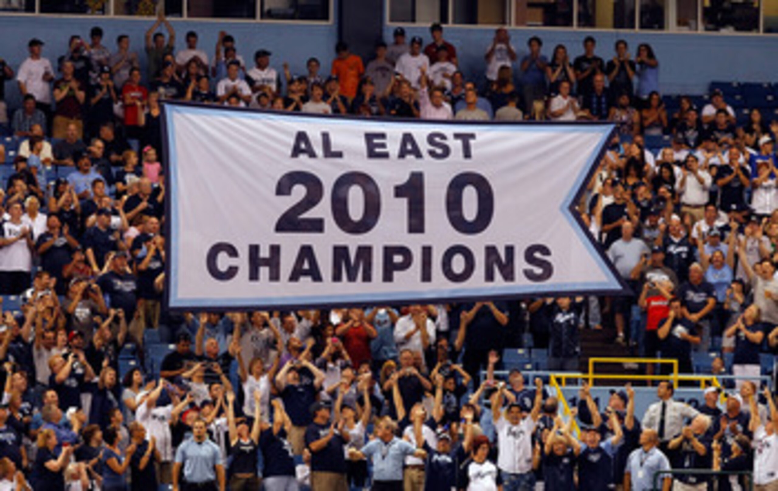 ST. PETERSBURG, FL - APRIL 01:  The Tampa Bay Rays raise their 2010 American League East championship banner just before the start of the Opening Day game against the Baltimore Orioles at Tropicana Field on April 1, 2011 in St. Petersburg, Florida.  (Phot