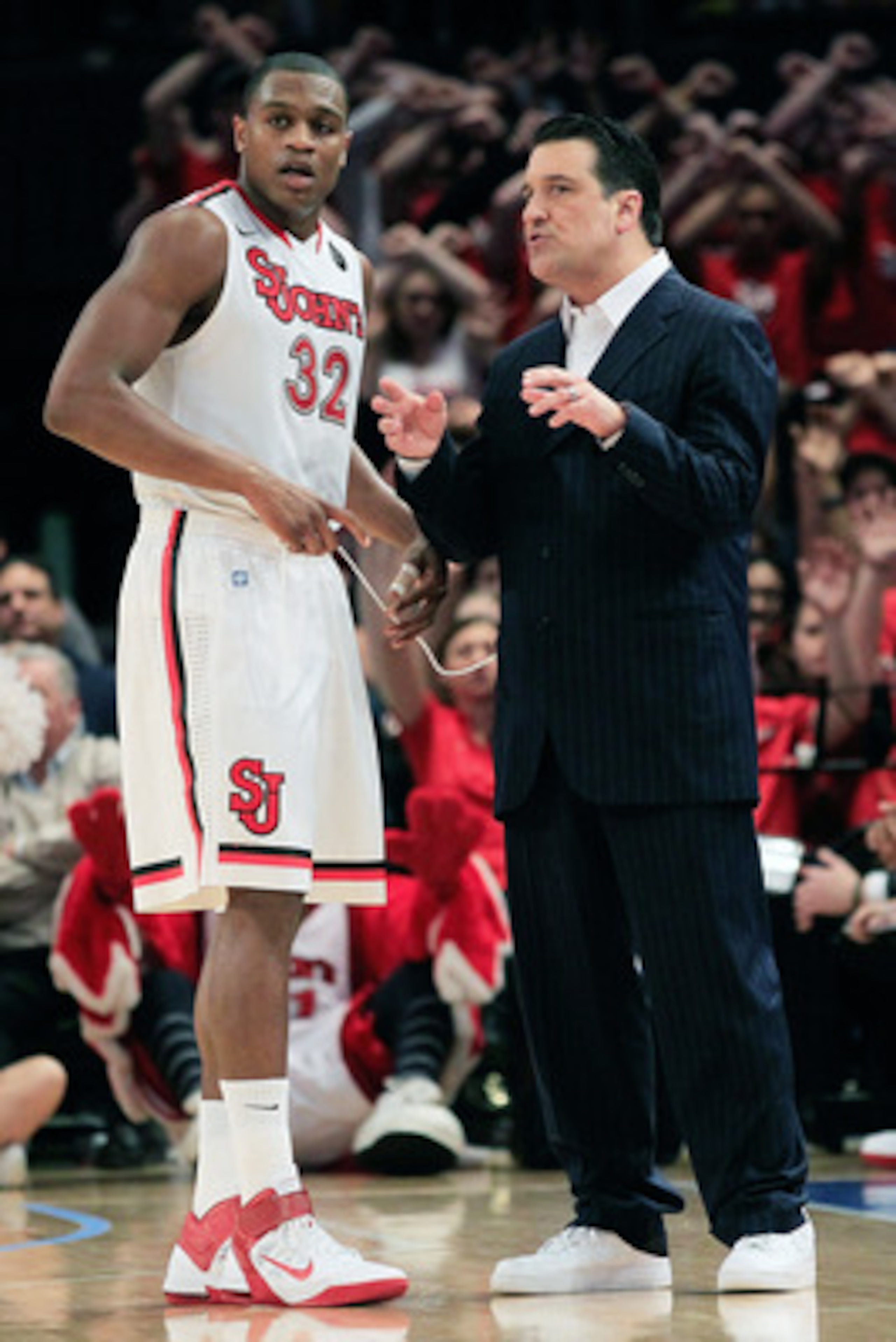 NEW YORK, NY - MARCH 09: Head coach Steve Lavin coaches his player Justin Brownlee #32  of the St.Johns Red Storm against the Rutgers Scarlet Knights during the second round of the 2011 Big East Men's Basketball Tournament presented by American Eagle Outf