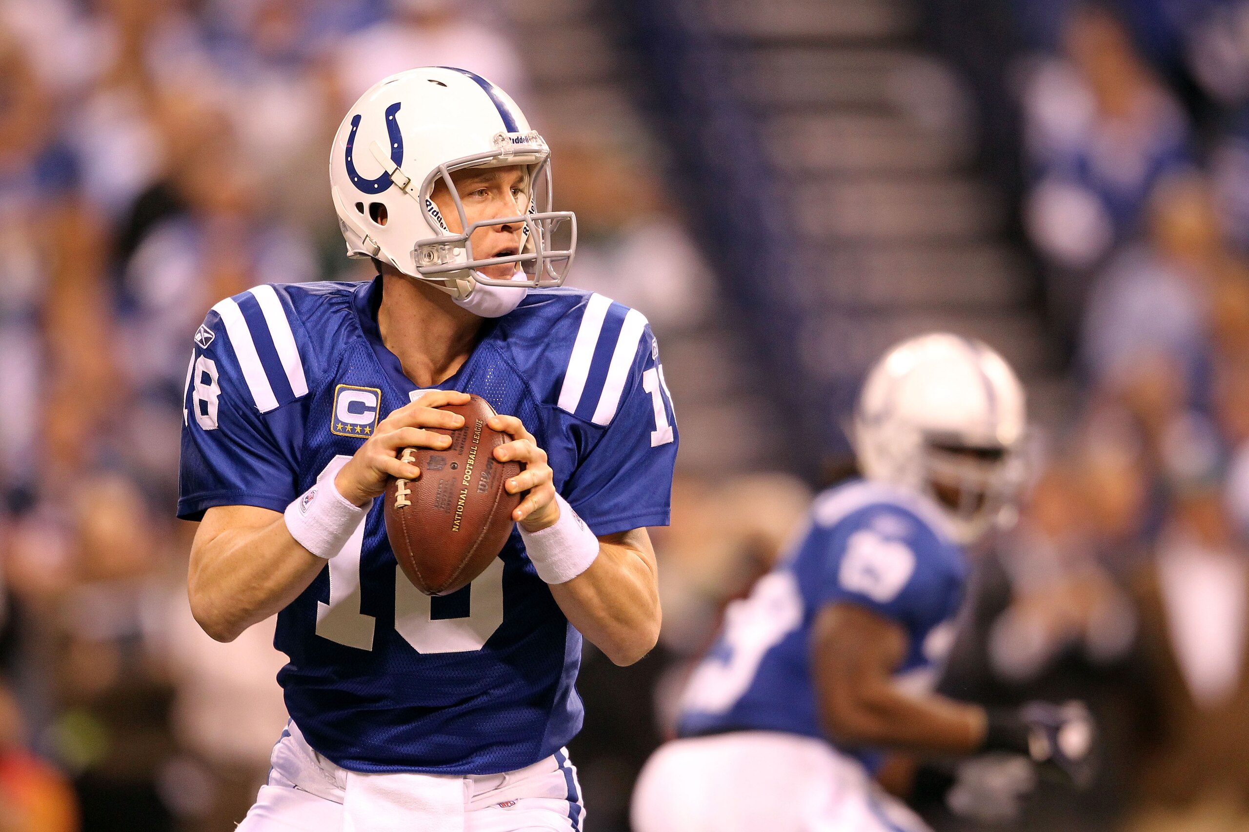 INDIANAPOLIS, IN - JANUARY 08:  Quarterback Peyton Manning #18 of the Indianapolis Colts looks to pass in the first quarter against the New York Jets during their 2011 AFC wild card playoff game at Lucas Oil Stadium on January 8, 2011 in Indianapolis, Ind