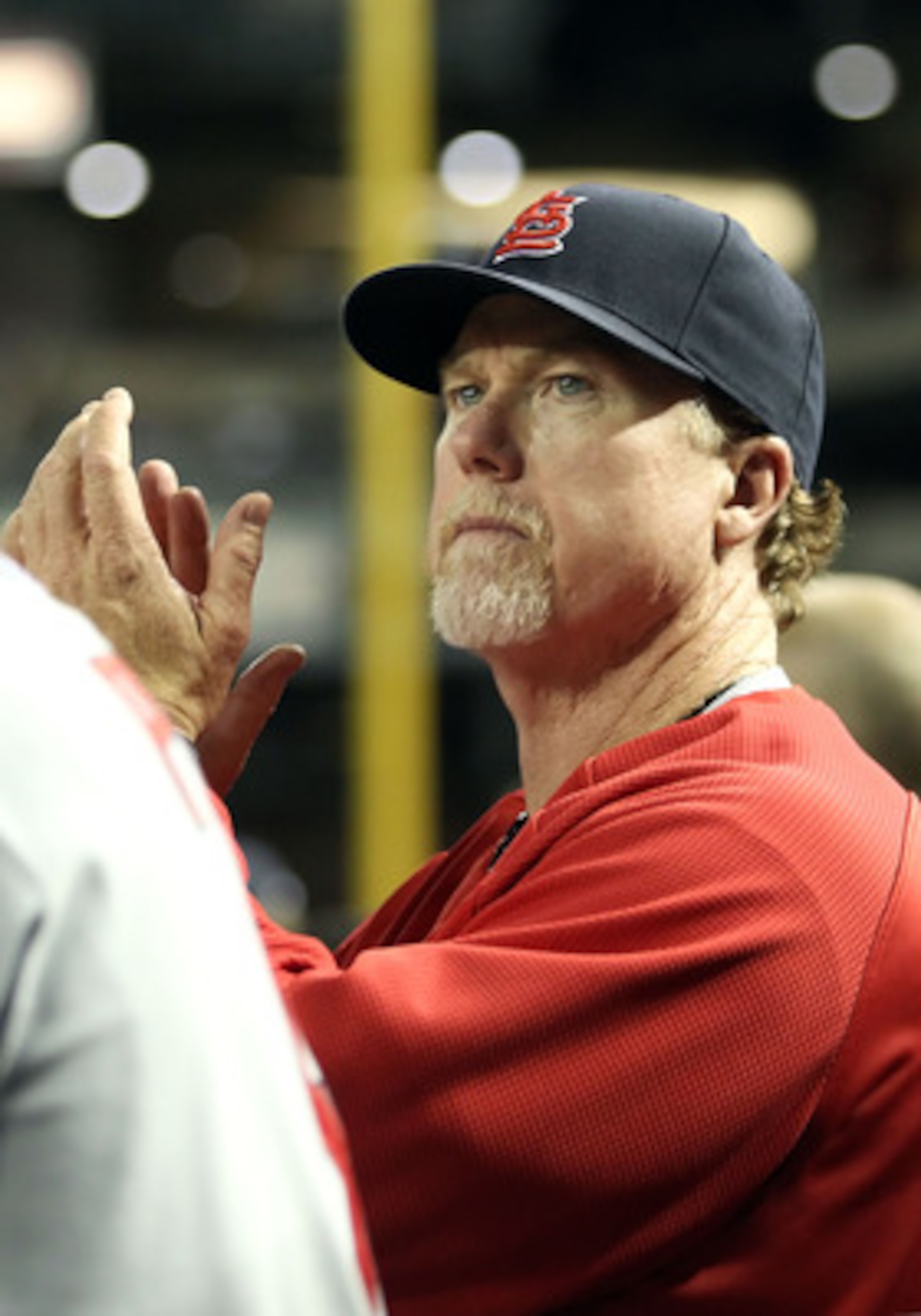 PHOENIX, AZ - APRIL 12:  Batting coach Mark McGwire of the St. Louis Cardinals watches from the dugout during the Major League Baseball game against the Arizona Diamondbacks at Chase Field on April 12, 2011 in Phoenix, Arizona.  The Diamondbacks defeated