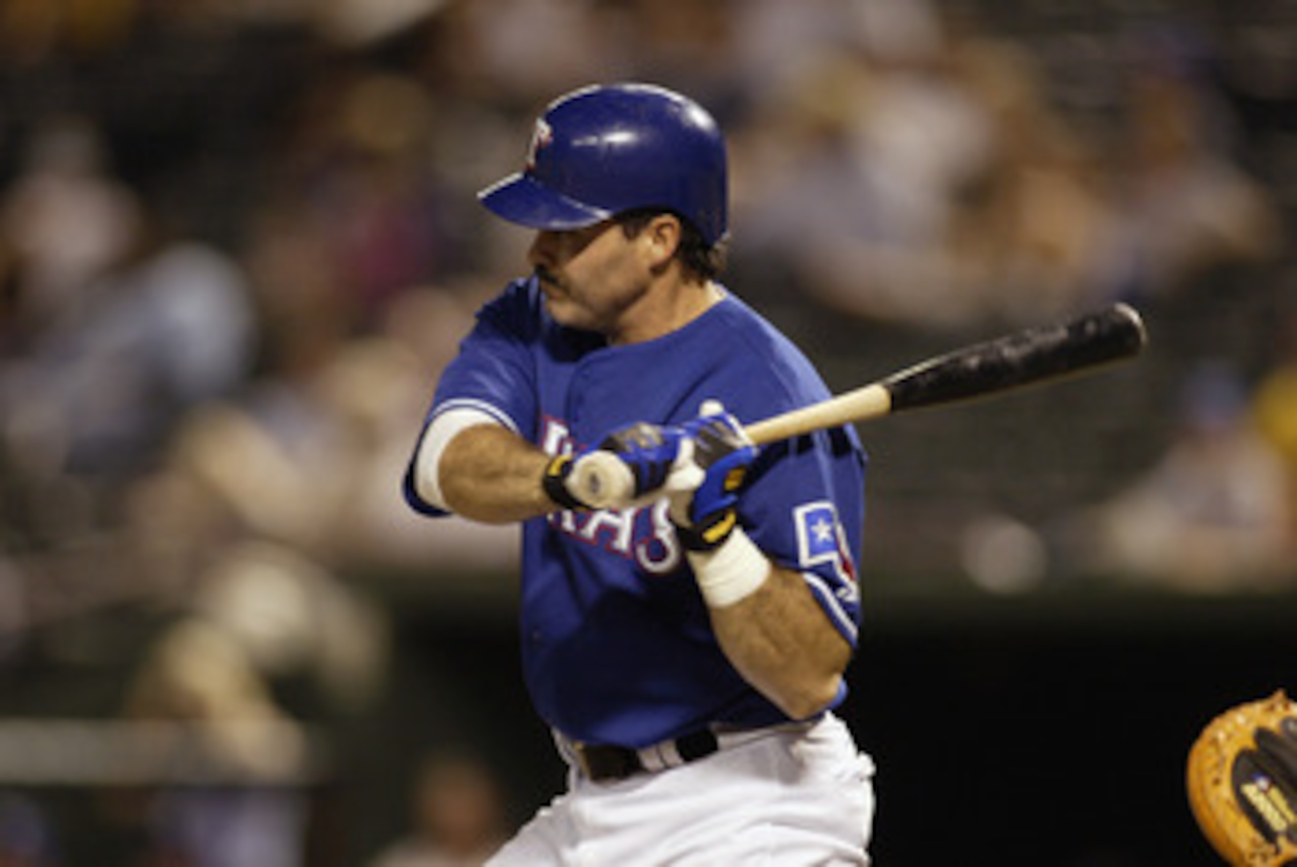 ARLINGTON, TX - JULY 11:  First baseman Rafael Palmeiro #25 of the Texas Rangers swings at a Kansas City Royals pitch during the MLB game at the Ballpark in Arlington on July 11, 2003 in Arlington, Texas. The Royals won 13-3.  (Photo by Ronald Martinez/Ge