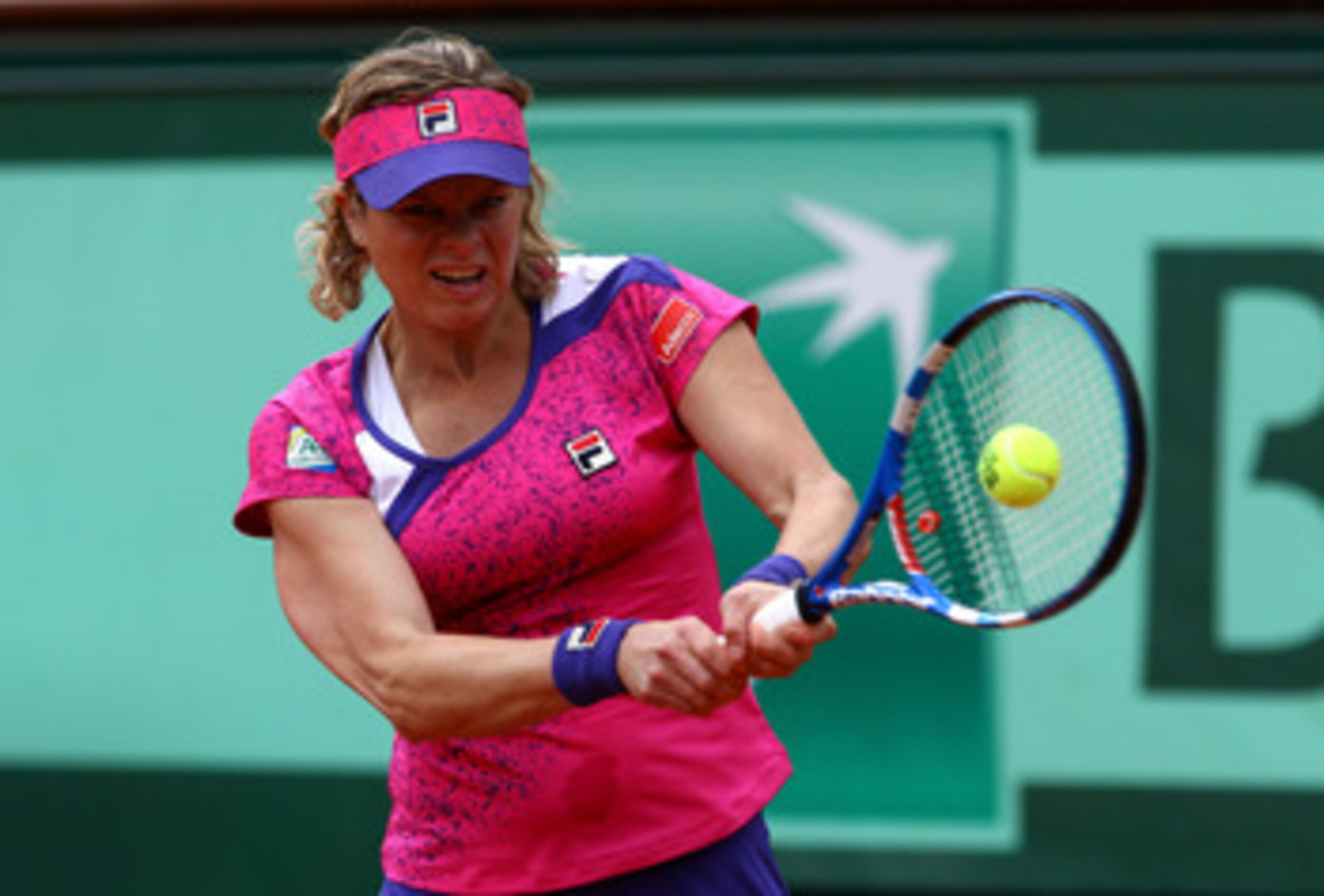 PARIS, FRANCE - MAY 26:  Kim Clijsters of Belgium hits a backhand during the women's singles round two match between Arantxa Rus of Netherlands and Kim Clijsters of Belgium on day five of the French Open at Roland Garros on May 26, 2011 in Paris, France.