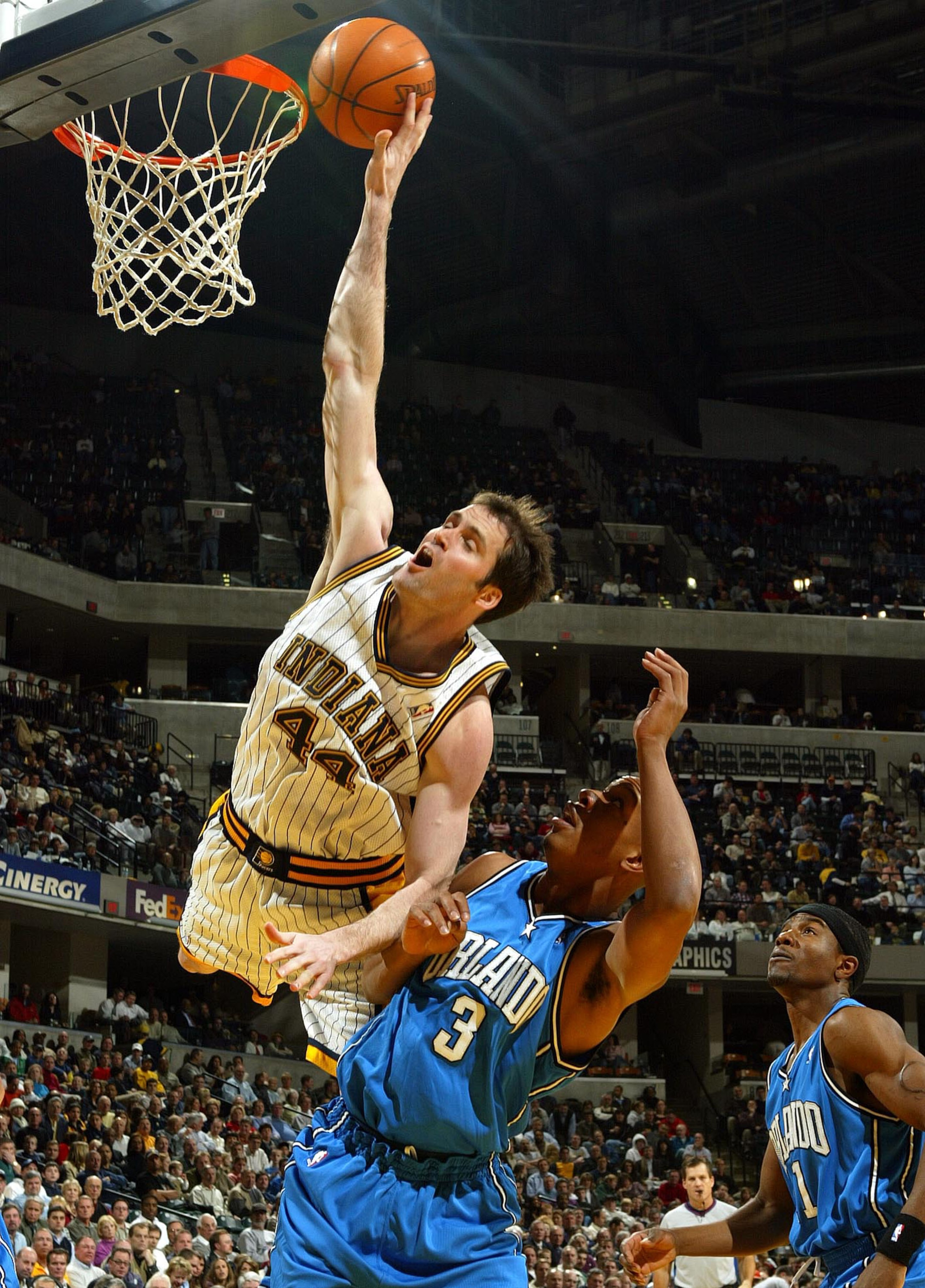 INDIANAPOLIS - DECEMBER 17:  Austin Croshere #44 of the Indiana Pacers tries to tip the ball in the basket while defended by Keith Bogans #3 of the Orlando Magic on December17, 2003 at Conseco Fieldhouse in Indianapolis, Indiana.  (Photo by Andy Lyons/Get