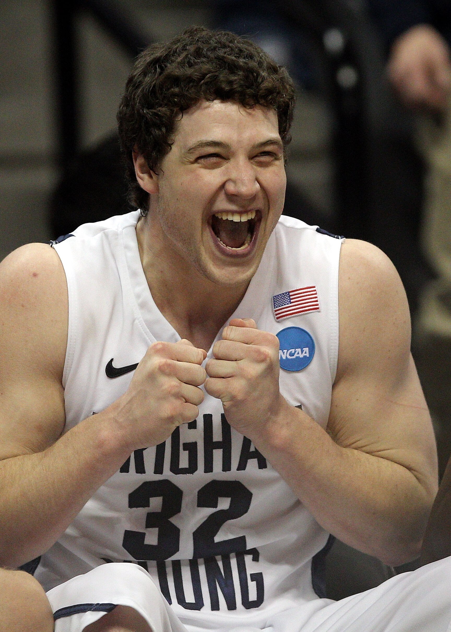 DENVER, CO - MARCH 19:  Jimmer Fredette #32 of the Brigham Young Cougars celebrates on the bench towards the end of the game against the Gonzaga Bulldogs during the third round of the 2011 NCAA men's basketball tournament at Pepsi Center on March 19, 2011