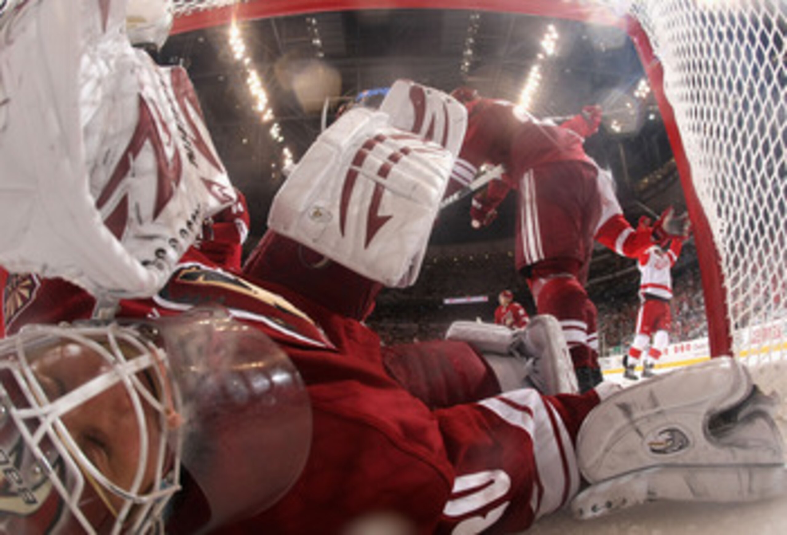 GLENDALE, AZ - APRIL 20:  Goaltender Ilya Bryzgalov #30 of the Phoenix Coyotes falls into the net after allowing a third period goal to Daniel Cleary (not pictured) of the Detroit Red Wings in Game Four of the Western Conference Quarterfinals during the 2