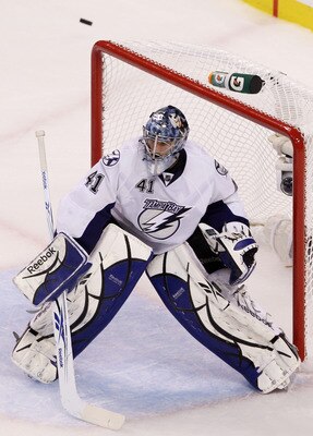 BOSTON, MA - MAY 23:  The puck flies high of the goal as Mike Smith #41 of the Tampa Bay Lightning defends against the Boston Bruins in Game Five of the Eastern Conference Finals during the 2011 NHL Stanley Cup Playoffs at TD Garden on May 23, 2011 in Bos