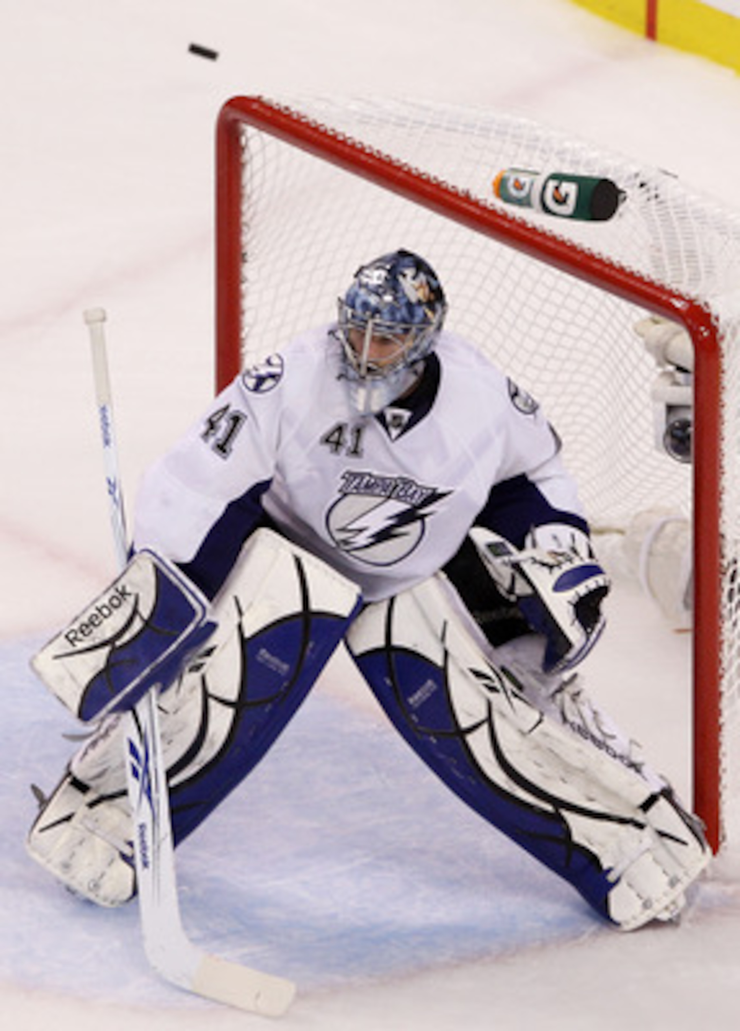BOSTON, MA - MAY 23:  The puck flies high of the goal as Mike Smith #41 of the Tampa Bay Lightning defends against the Boston Bruins in Game Five of the Eastern Conference Finals during the 2011 NHL Stanley Cup Playoffs at TD Garden on May 23, 2011 in Bos
