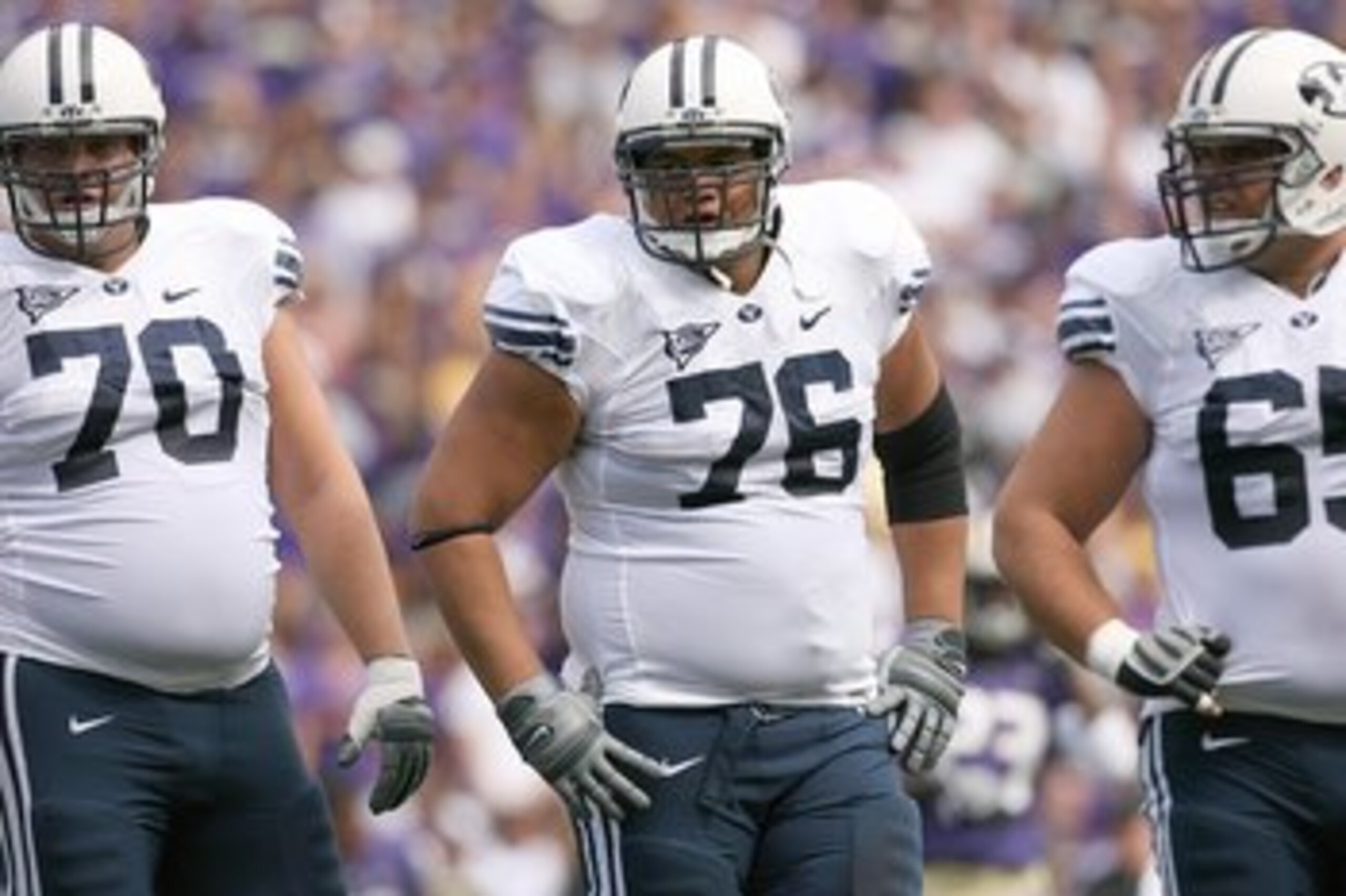 SEATTLE - SEPTEMBER 6:  (L-R) Matt Reynolds #70, Ray Feinga #76 and Dallas Reynolds #65 of the BYU Cougars look on during a break in game action against the Washington Huskies on September 6, 2008 at Husky Stadium in Seattle, Washington. The Cougars defea
