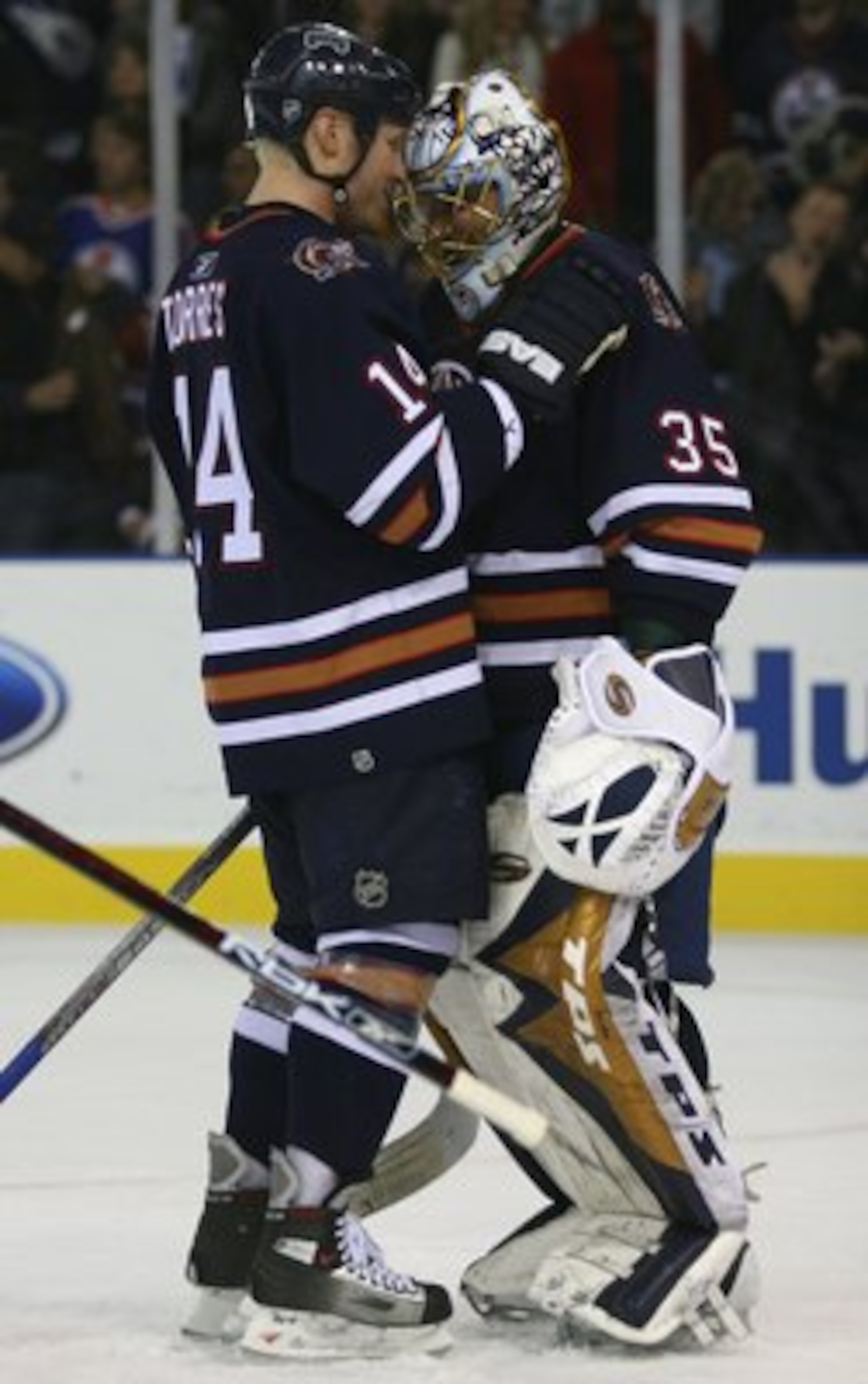 EDMONTON, AB - OCTOBER 12:  Raffi Torres #14 of the Edmonton Oilers congratulates Oilers goalie Dwayne Roloson #35 after the Oilers 6-4 victory over the San Jose Sharks at Rexall Place on October 12, 2006 in Edmonton, Alberta, Canada. Smyth scored three g