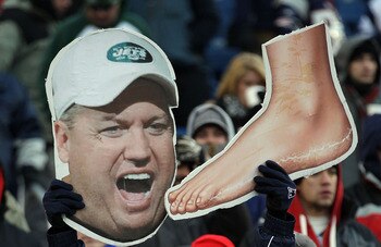 FOXBORO, MA - JANUARY 16:  New England Patriots fans hold up signs picturing head coach Rex Ryan of the New York Jets and a foot prior to their 2011 AFC divisional playoff game at Gillette Stadium on January 16, 2011 in Foxboro, Massachusetts.  (Photo by
