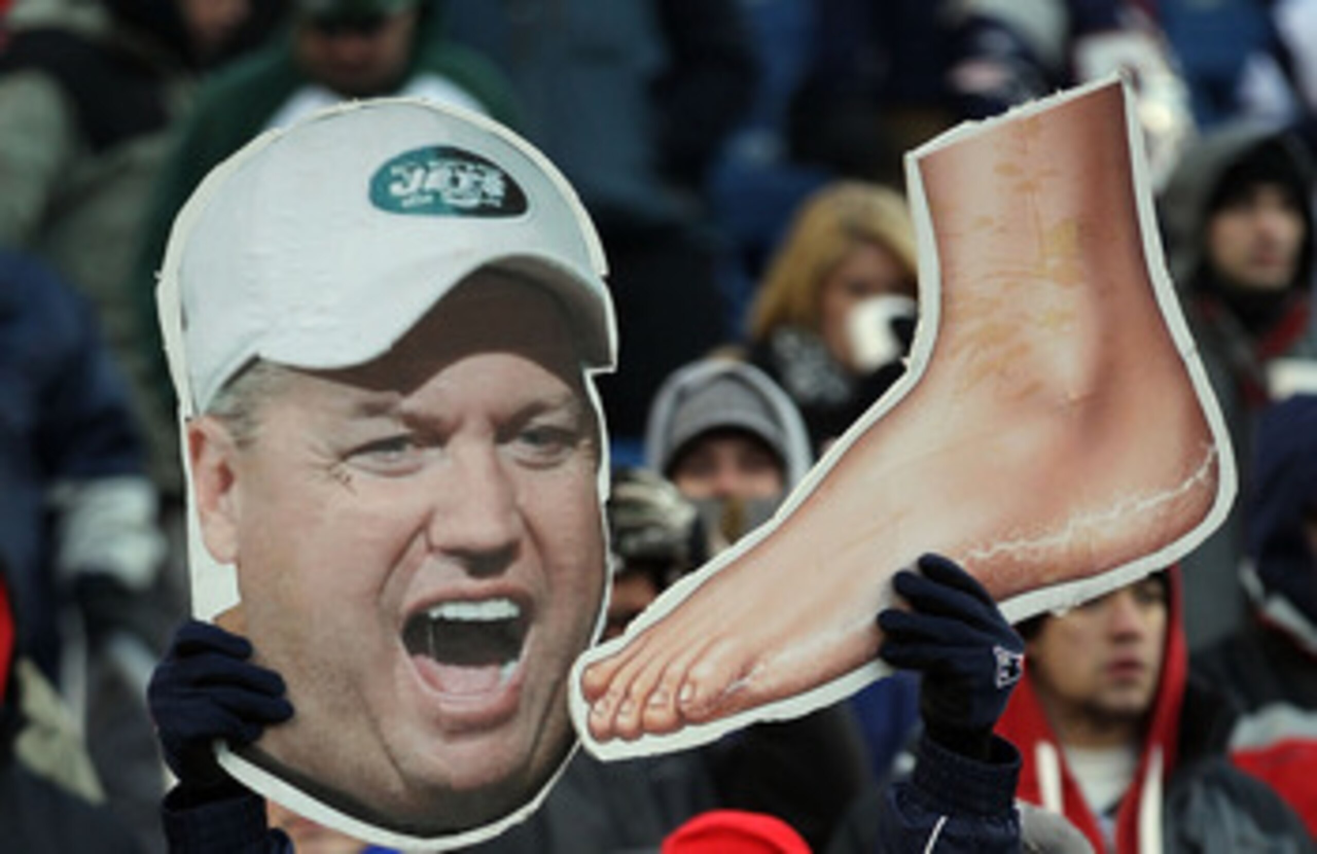 FOXBORO, MA - JANUARY 16: New England Patriots fans hold up signs picturing head coach Rex Ryan of the New York Jets and a foot prior to their 2011 AFC divisional playoff game at Gillette Stadium on January 16, 2011 in Foxboro, Massachusetts. (Photo by FOXBORO, MA - JANUARY 16: New England Patriots fans hold up signs picturing head coach Rex Ryan of the New York Jets and a foot prior to their 2011 AFC divisional playoff game at Gillette Stadium on January 16, 2011 in Foxboro, Massachusetts. (Photo by
