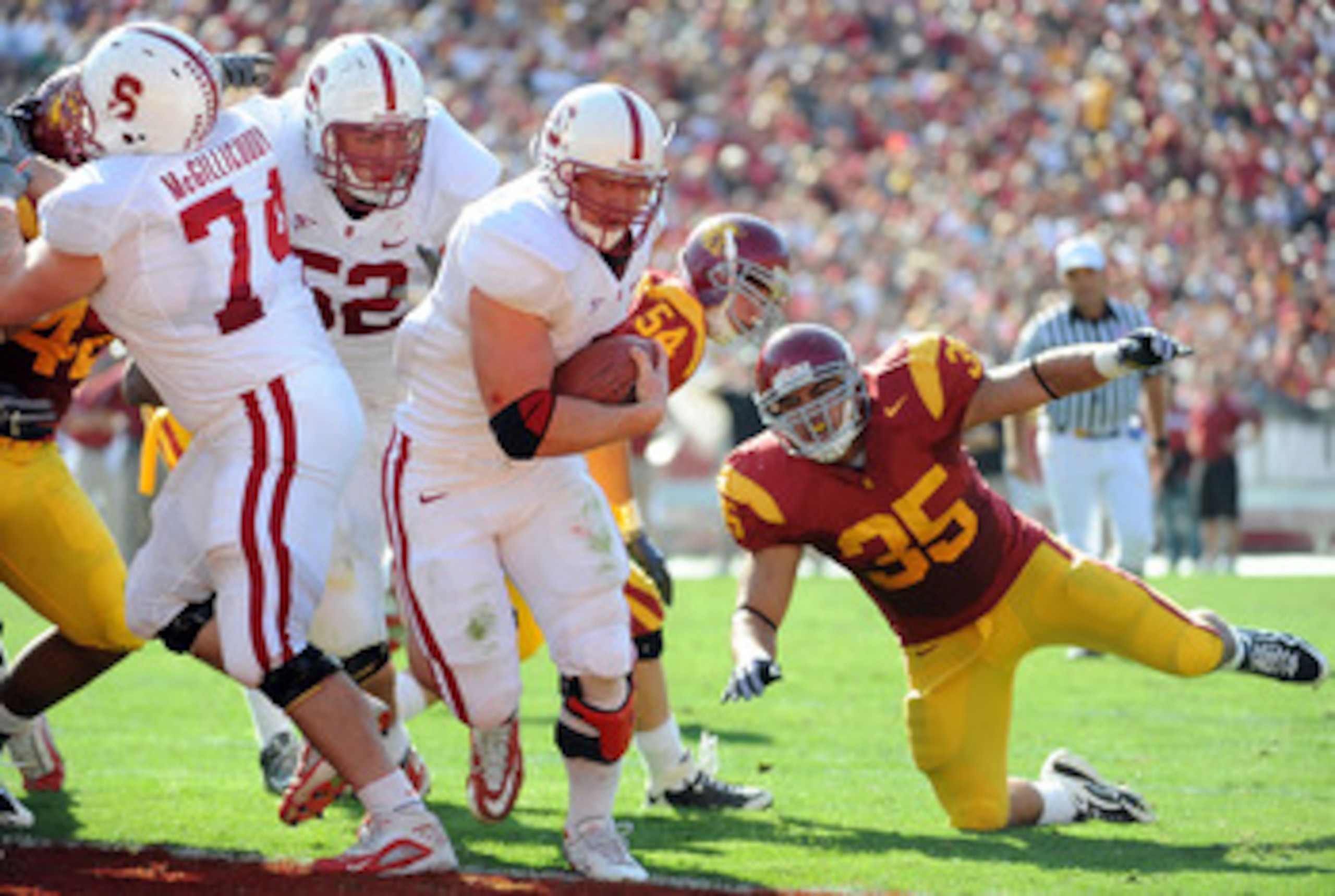 LOS ANGELES, CA - NOVEMBER 14:  Toby Gerhart #7 of the Stanford Cardinal runs in for a touchdown past a fallen Uona Kaveinga #35 of the USC Trojans for a 14-0 lead during the first half at the Los Angeles Memorial Coliseum on November 14, 2009 in Los Ange