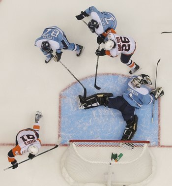 UNIONDALE, NY - NOVEMBER 27:  Brent Johnson #1 of the Pittsburgh Penguins tends net against Matt Moulson #26 and John Tavares #91 of the New York Islanders at the Nassau Coliseum on November 27, 2009 in Uniondale, New York.  (Photo by Bruce Bennett/Getty 