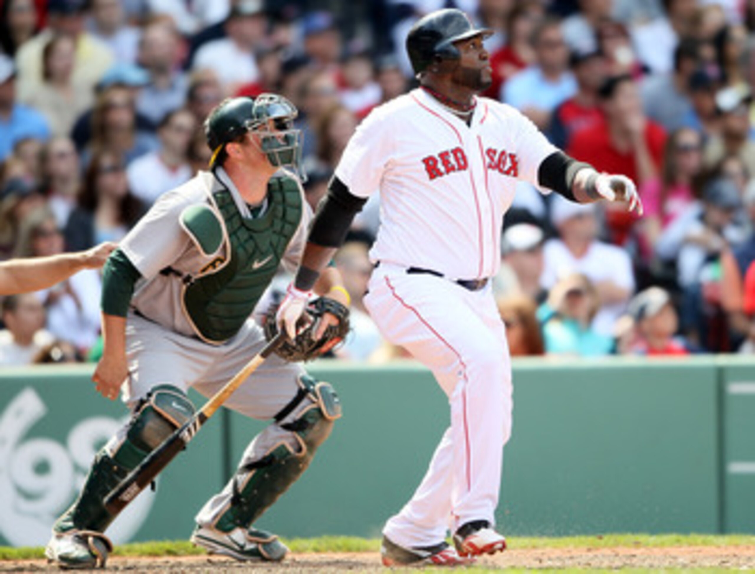 BOSTON, MA - JUNE 04:  David Ortiz #34 of the Boston Red Sox hits a double in the eighth inning as Landon Powell #11 of the Oakland Athletics catches on June 4, 2011 at Fenway Park in Boston, Massachusetts.  (Photo by Elsa/Getty Images)