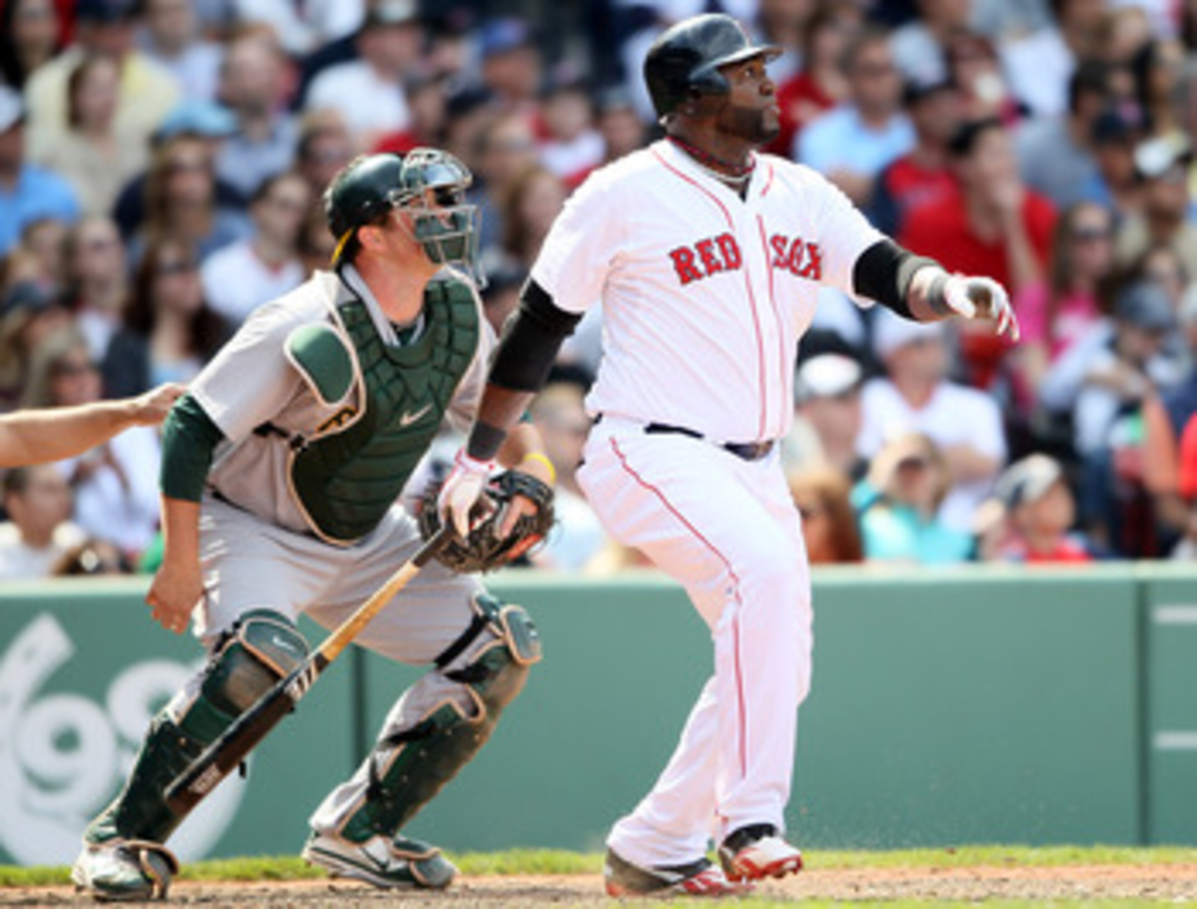BOSTON, MA - JUNE 04:  David Ortiz #34 of the Boston Red Sox hits a double in the eighth inning as Landon Powell #11 of the Oakland Athletics catches on June 4, 2011 at Fenway Park in Boston, Massachusetts.  (Photo by Elsa/Getty Images)