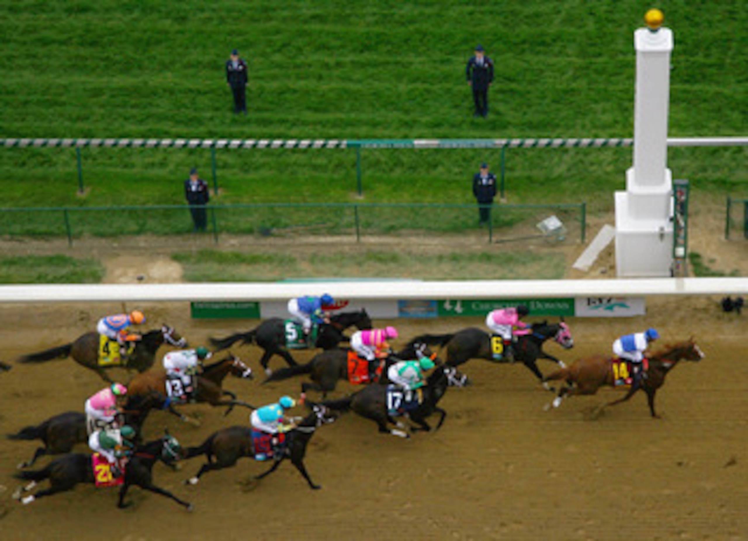 LOUISVILLE, KY - MAY 07:  The pack of horses races past the finish line during the 137th Kentucky Derby at Churchill Downs on May 7, 2011 in Louisville, Kentucky.  (Photo by Jamie Squire/Getty Images)