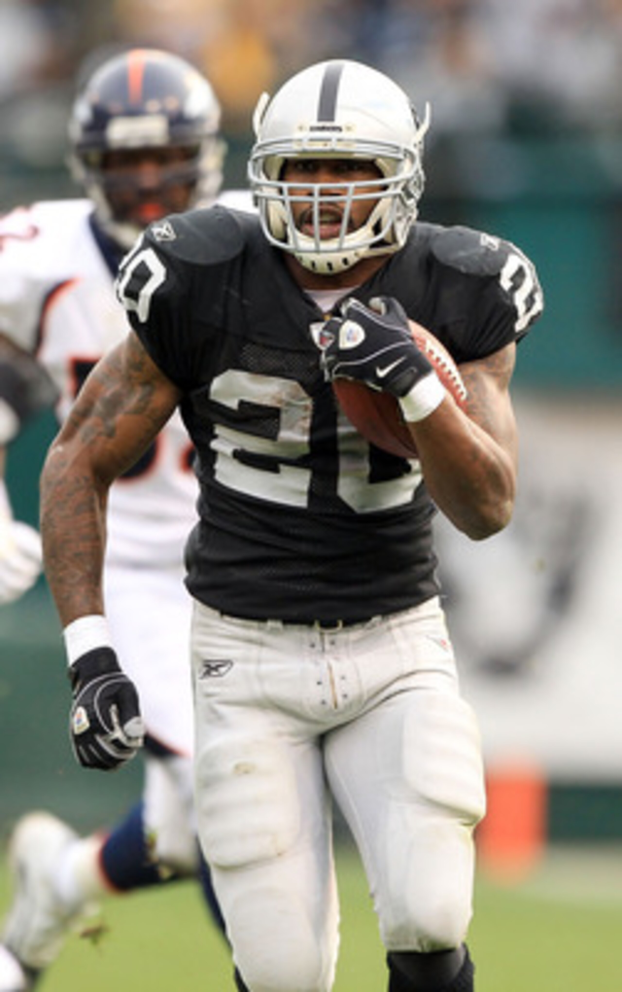 OAKLAND, CA - DECEMBER 19:  Darren McFadden #20 of the Oakland Raiders runs with the ball during their game against the Denver Broncos at Oakland-Alameda County Coliseum on December 19, 2010 in Oakland, California.  (Photo by Ezra Shaw/Getty Images)