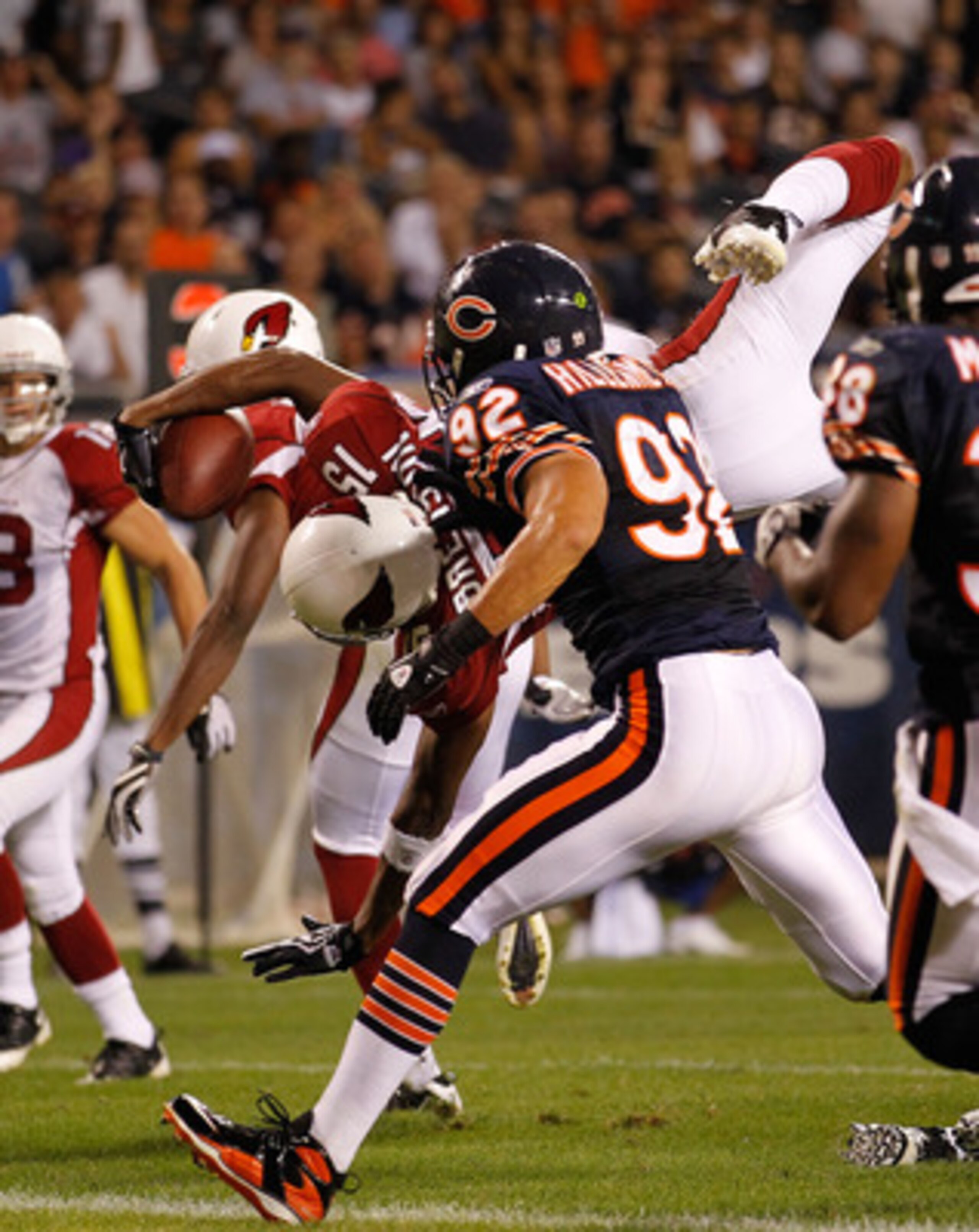 CHICAGO - AUGUST 28: Steve Breaston #15 of the Arizona Cardinals dives in to the end zone for a touchdown as Hunter Hillenmeyer #92 of the Chicago Bears pursues during a preseason game at Soldier Field on August 28, 2010 in Chicago, Illinois. The Cardinal