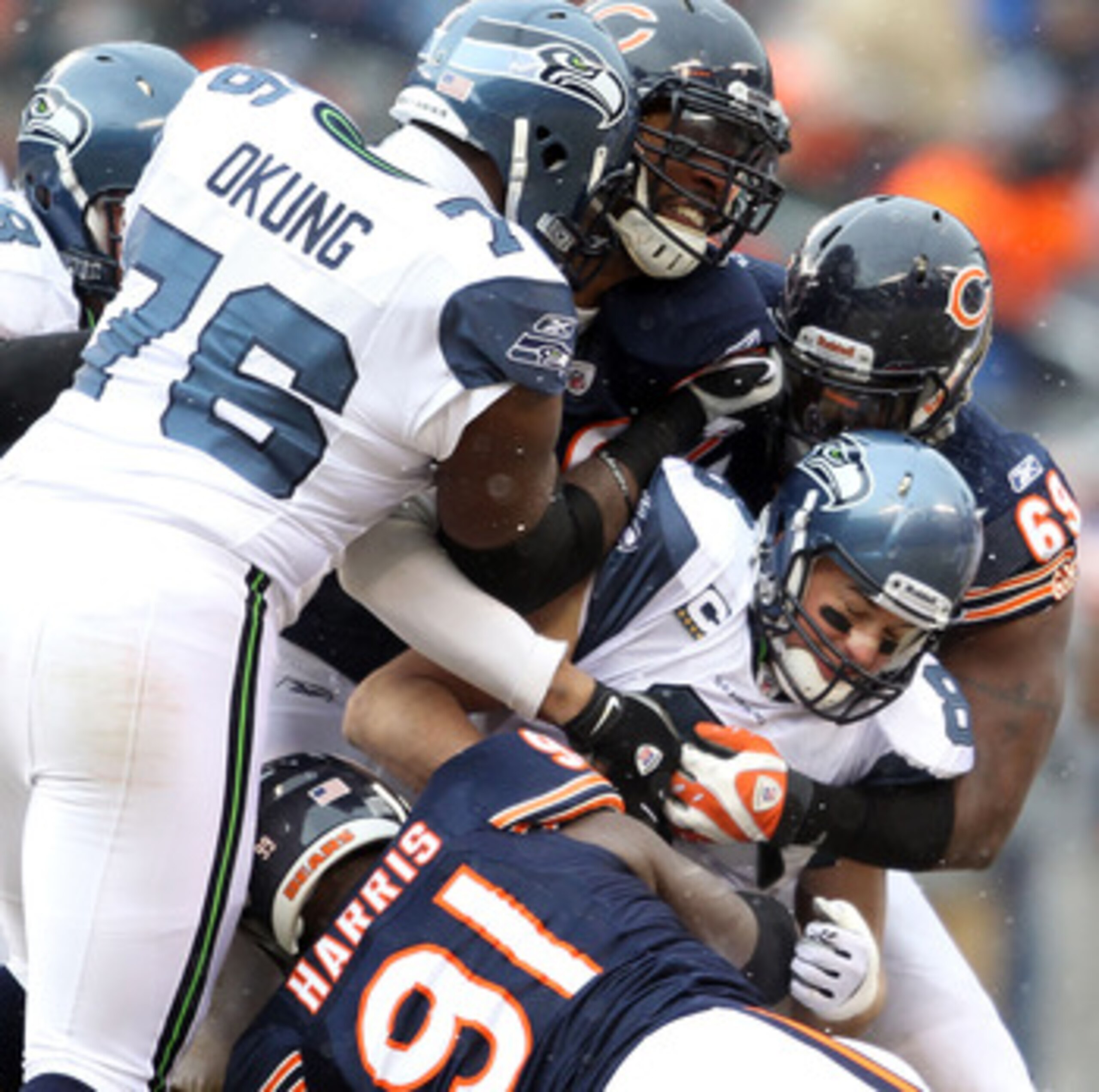 CHICAGO, IL - JANUARY 16:  Quarterback Matt Hasselbeck #8 of the Seattle Seahawks is sacked by three members of the Chicago Bears defense in the first half during the 2011 NFC divisional playoff game at Soldier Field on January 16, 2011 in Chicago, Illino