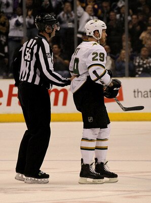 LOS ANGELES, CA - MARCH 7:  Linesman Mark Wheeler skates Steve Ott #29 of the Dallas Stars off the ice after Ott received a game misconduct penalty for spearing against the Los Angeles Kings at Staples Center on March 7, 2011 in Los Angeles, California.  