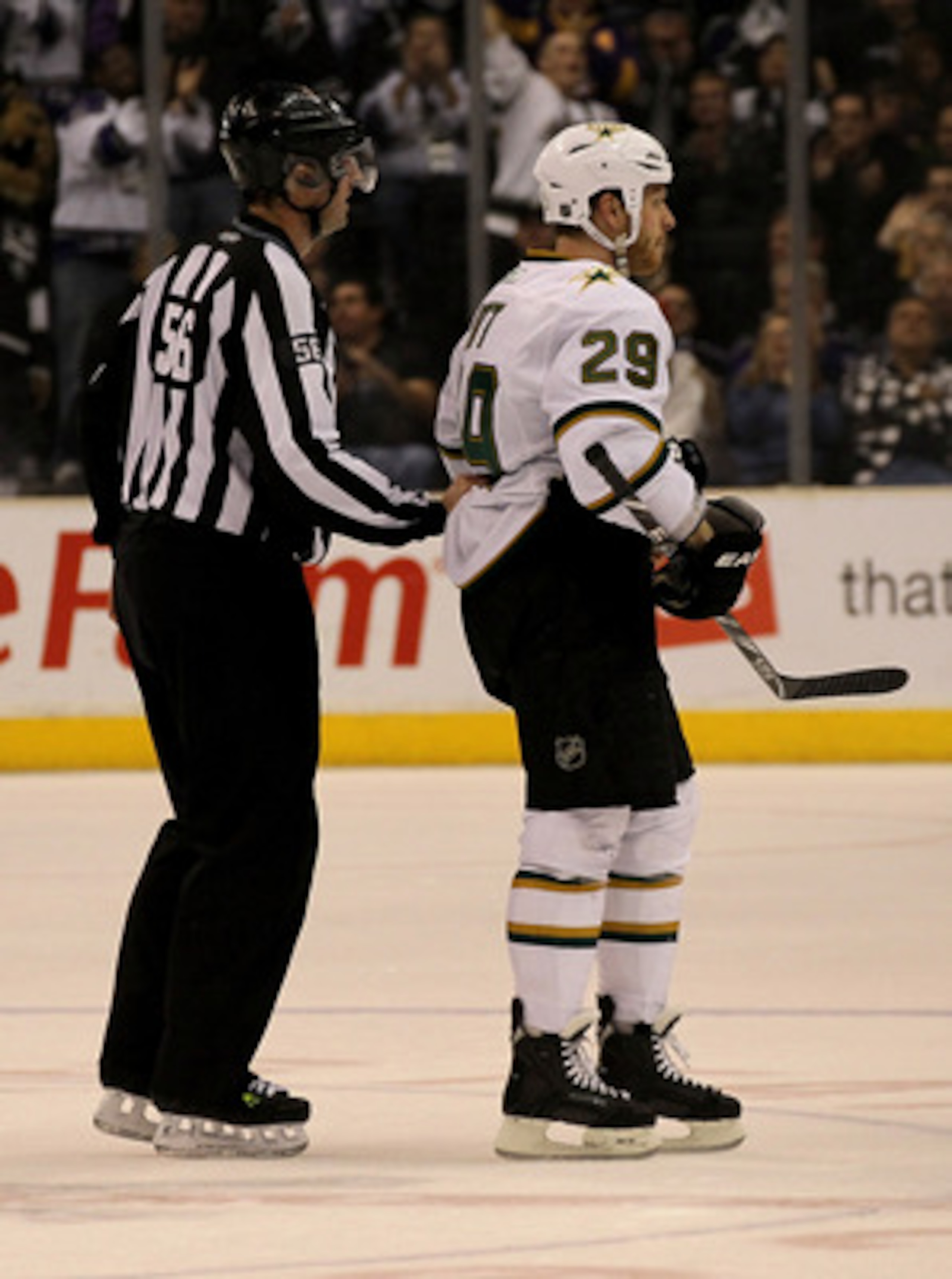 LOS ANGELES, CA - MARCH 7:  Linesman Mark Wheeler skates Steve Ott #29 of the Dallas Stars off the ice after Ott received a game misconduct penalty for spearing against the Los Angeles Kings at Staples Center on March 7, 2011 in Los Angeles, California.  