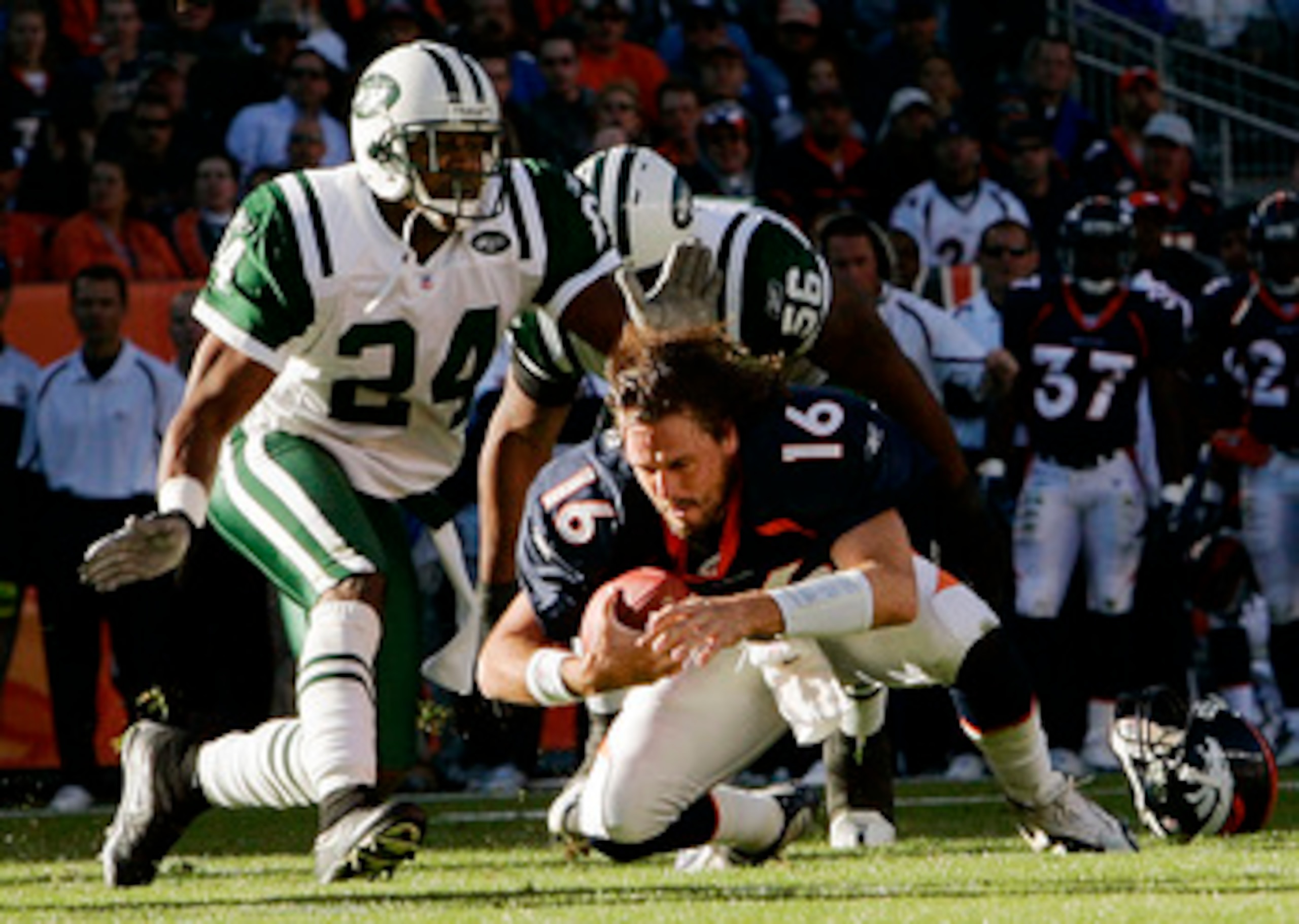DENVER - NOVEMBER 20: Quarterback Jake Plummer #16 of the Denver Broncos dives for the ground after losing his helmet to linebacker John Abraham #56 and cornerback Ty Law #24 of the New York Jets in the second quarter on November 20, 2005 at Invesco Fiel DENVER - NOVEMBER 20: Quarterback Jake Plummer #16 of the Denver Broncos dives for the ground after losing his helmet to linebacker John Abraham #56 and cornerback Ty Law #24 of the New York Jets in the second quarter on November 20, 2005 at Invesco Fiel